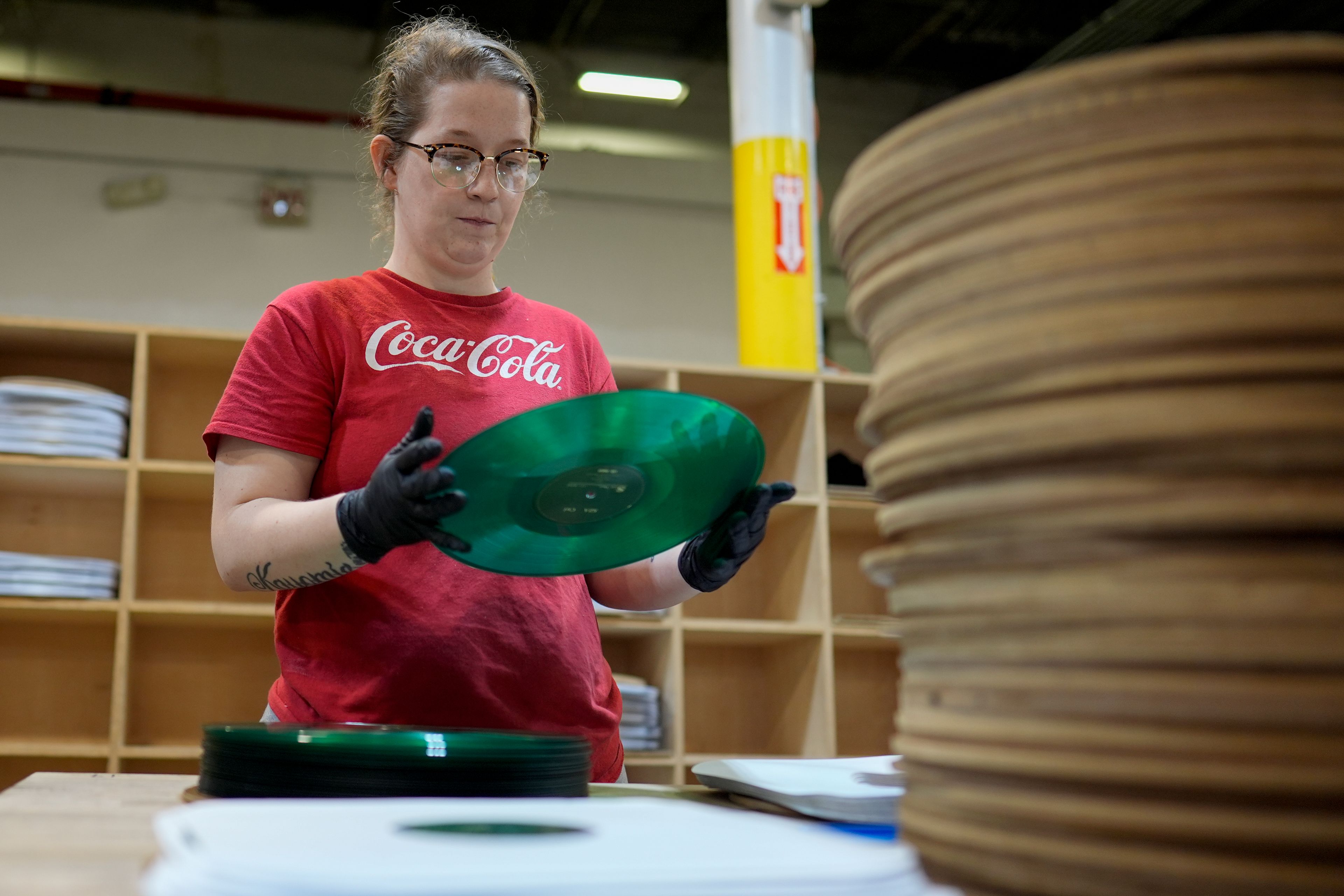 Tannika Benjamin inspects a vinyl record at the United Record Pressing plant July 11, 2024, in Nashville, Tenn. (AP Photo/George Walker IV)