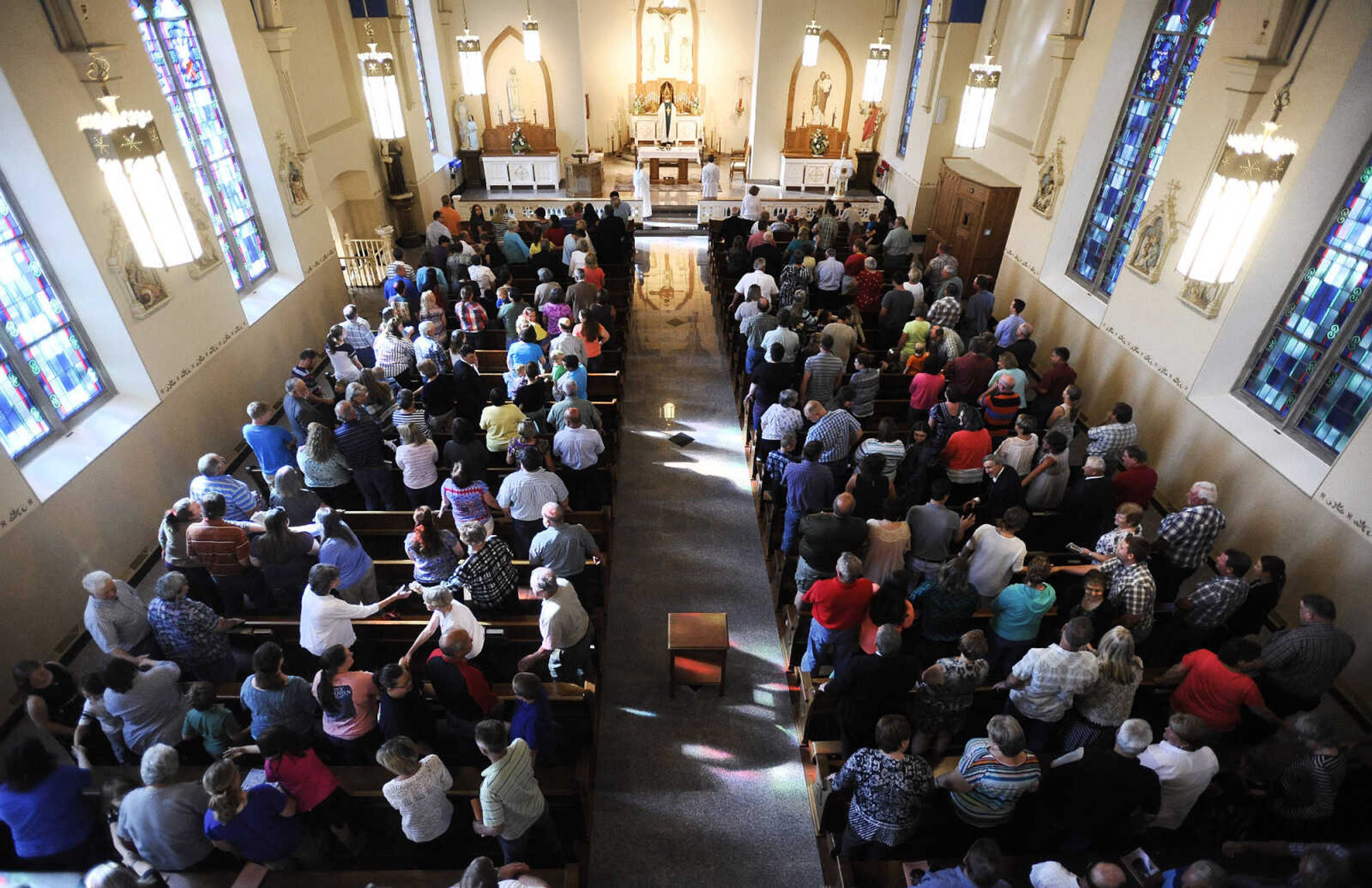 LAURA SIMON ~ lsimon@semissourian.com

Parishioners turn to each other in a sign of peace during the first mass inside the newly remodeled St. John's Catholic Church in Leopold, Missouri on Sunday, May 29, 2016.