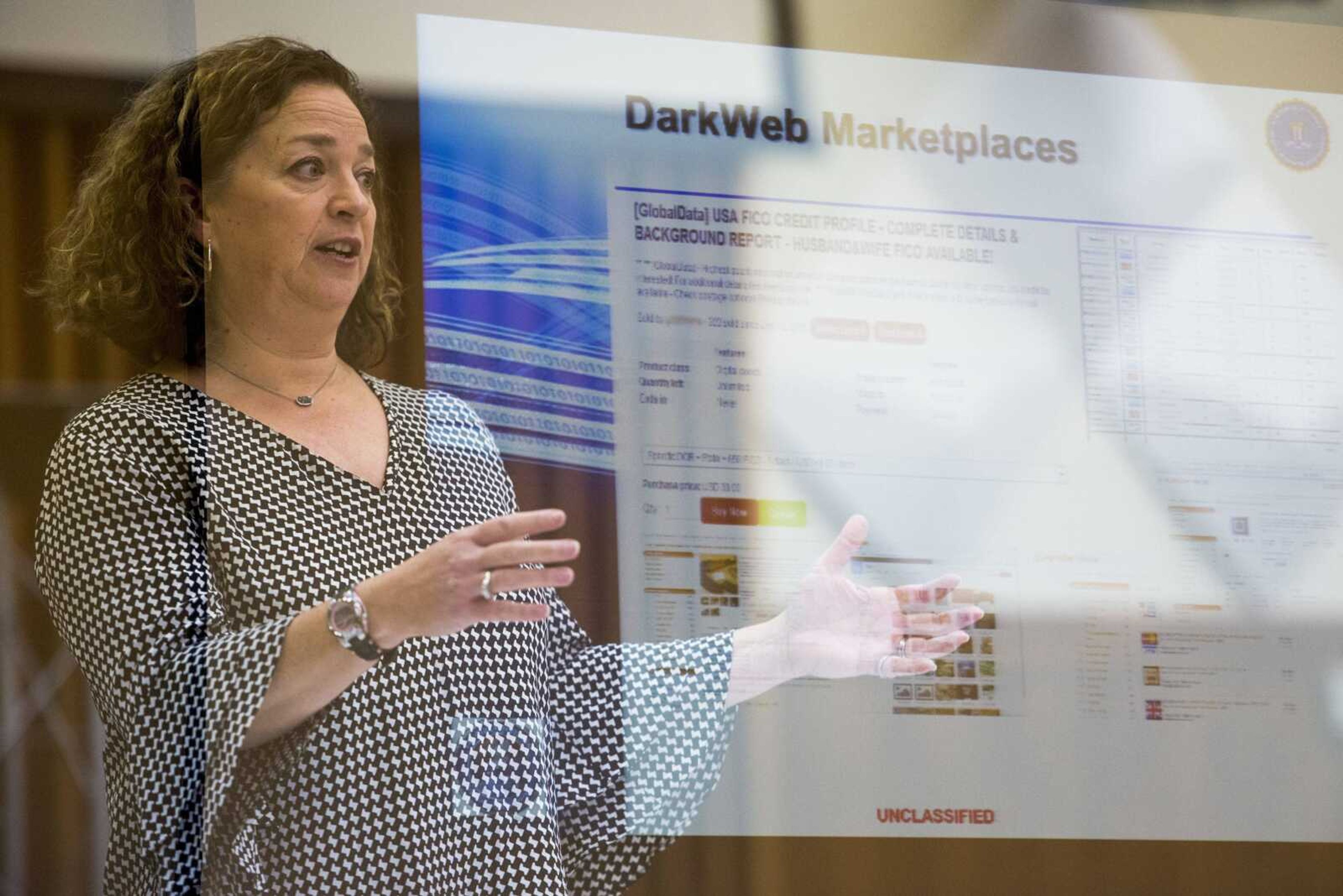 In this in-camera double exposure photograph, FBI special agent Monique Comeau of St. Louis speaks about cybersecurity Thursday to attendees of a Better Business Bureau luncheon inside the former federal building at 339 Broadway in Cape Girardeau.