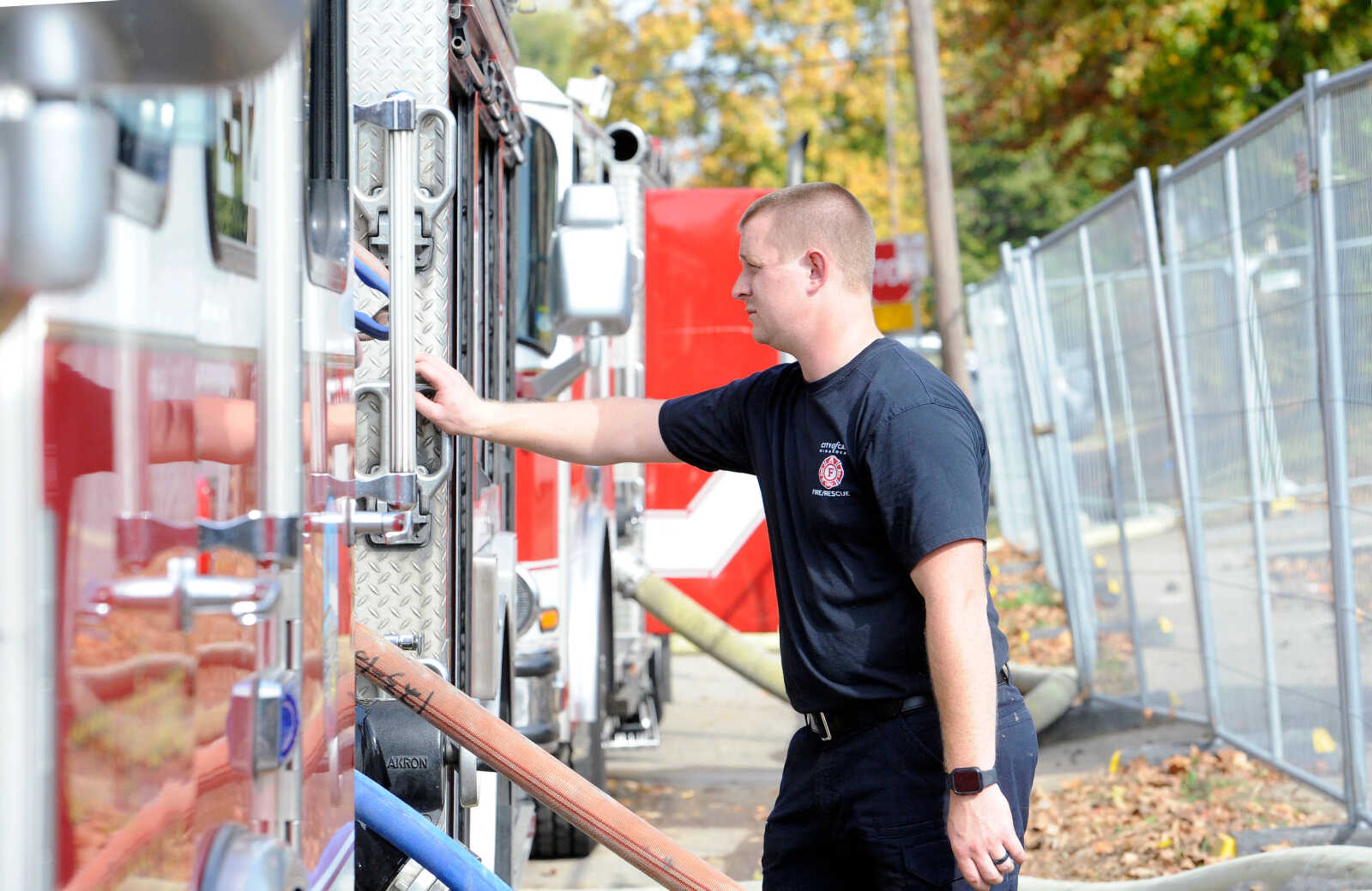 Cape Girardeau firefighter Jacob Farmer controls the hose from the truck at the live burn exercise on Friday, Oct. 23, 2020, held by the Cape Girardeau Fire Department at 222 N. Middle St. in Cape Girardeau.