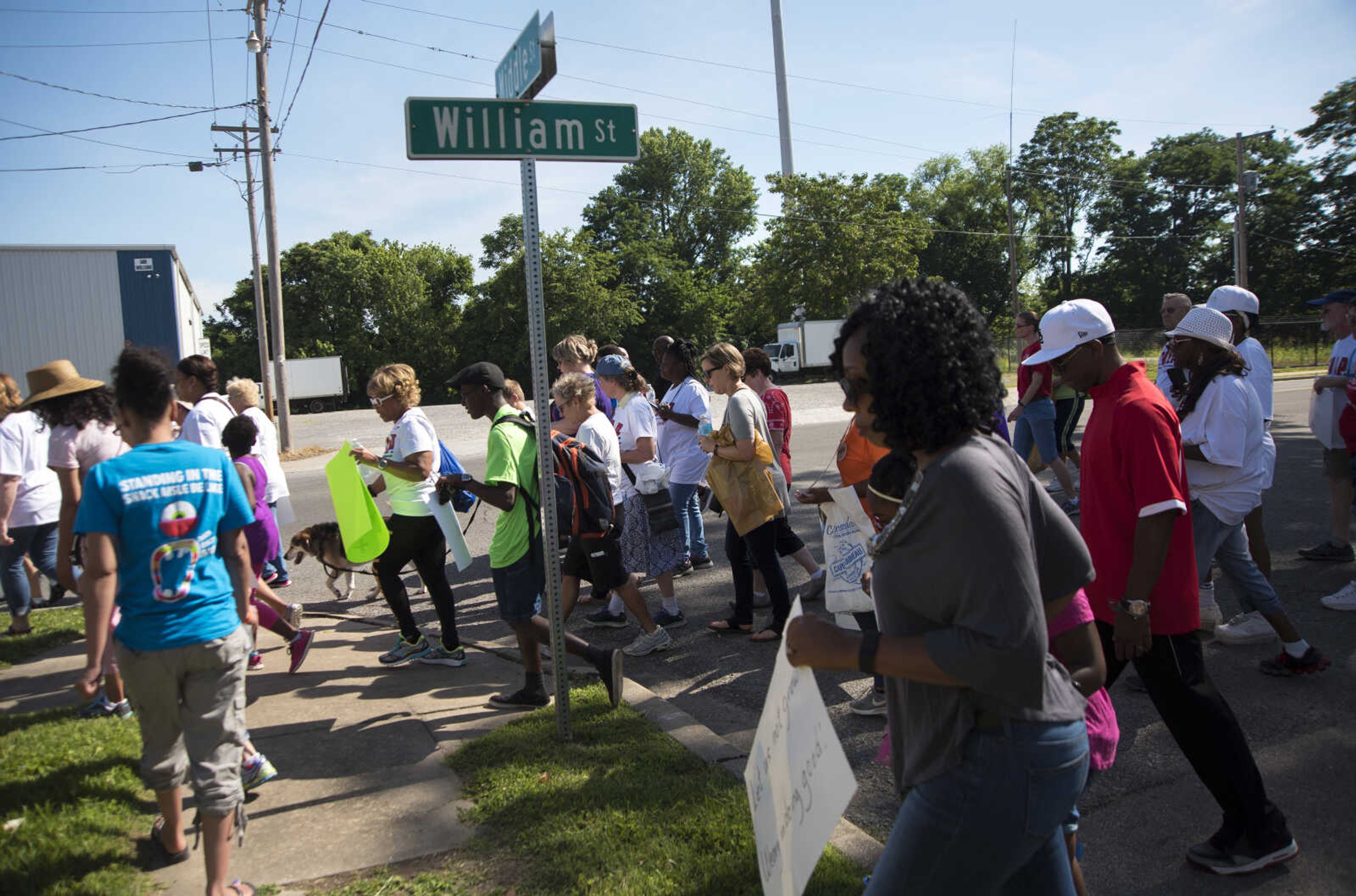 Community Members march during a Stop Needless Acts of Violence Please (SNAP) prayer march Saturday, June 10, 2017 in Cape Girardeau.