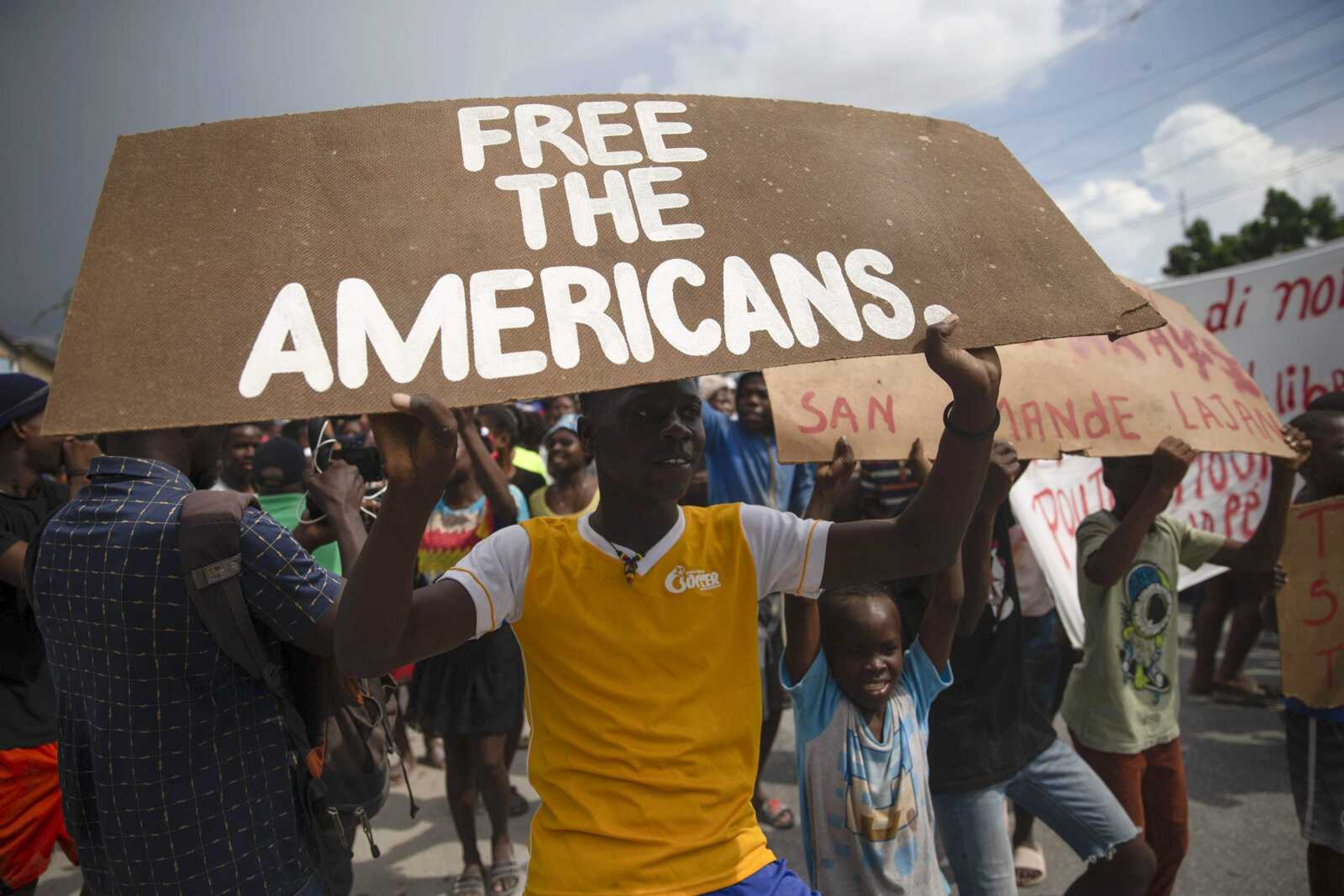 People protest for the release of kidnapped missionaries near the missionaries' headquarters Tuesday in Titanyen, north of Port-au-Prince, Haiti.