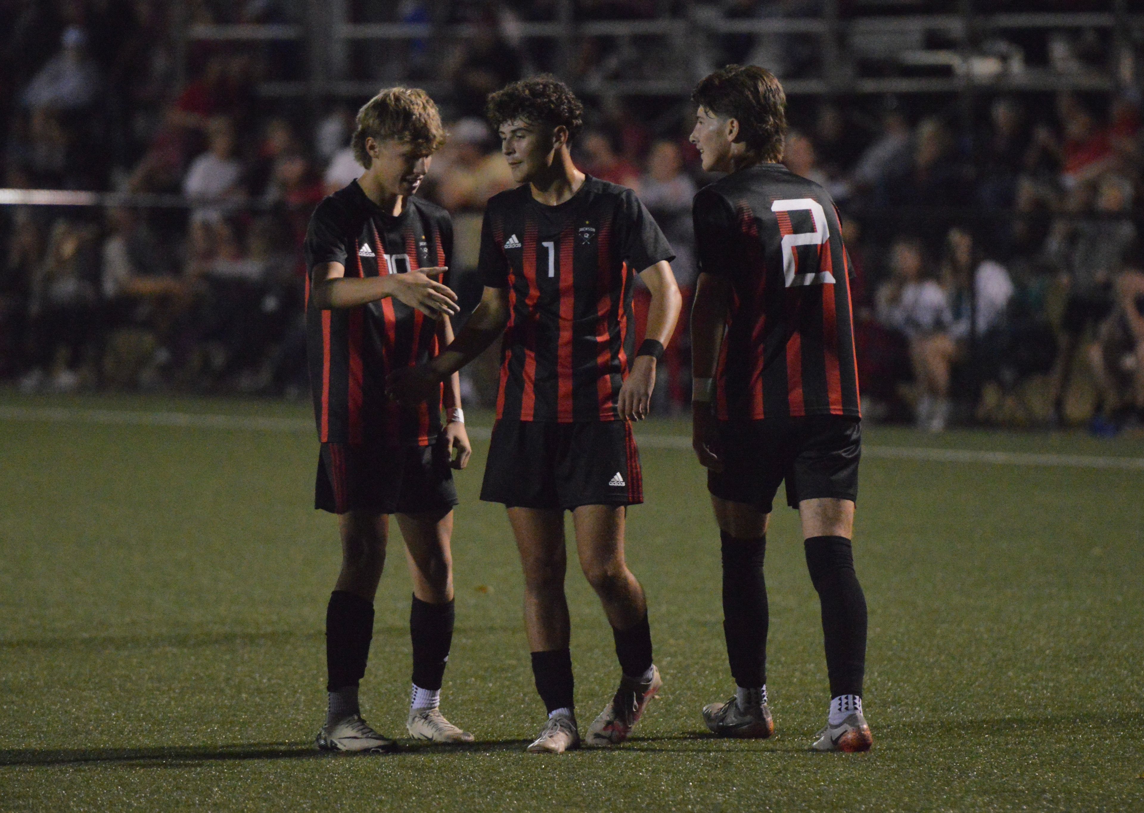 Jackson junior Dylan Strothmann, middle, celebrates with teammates Mason Jackson, left, and Luke Simmons, right, after scoring a goal against Notre Dame on Tuesday, Oct. 29. The Indians shut out the Bulldogs 6-0.