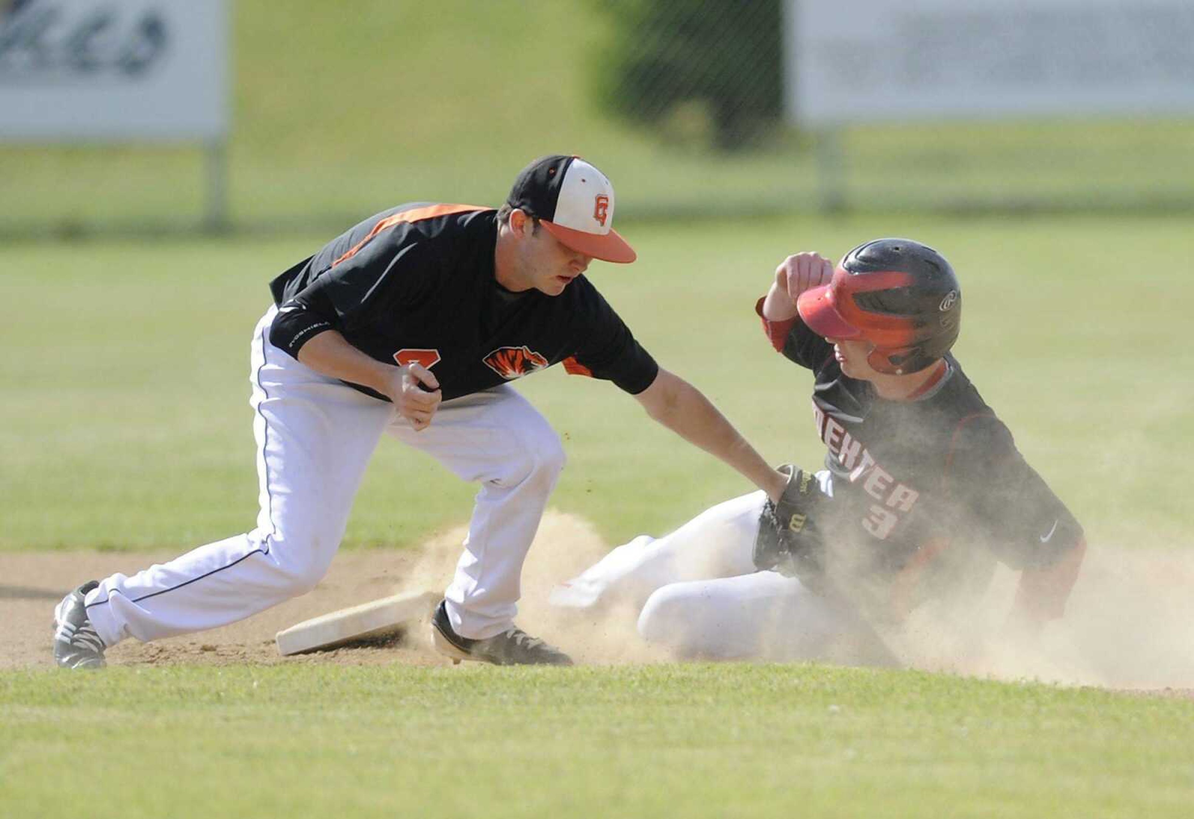 Central second baseman Luke Hinkebein tags out Dexter&#8217;s Chase Young on Monday at Central High School. Dexter won 6-2. More photos can be viewed at semoball.com. (ADAM VOGLER)