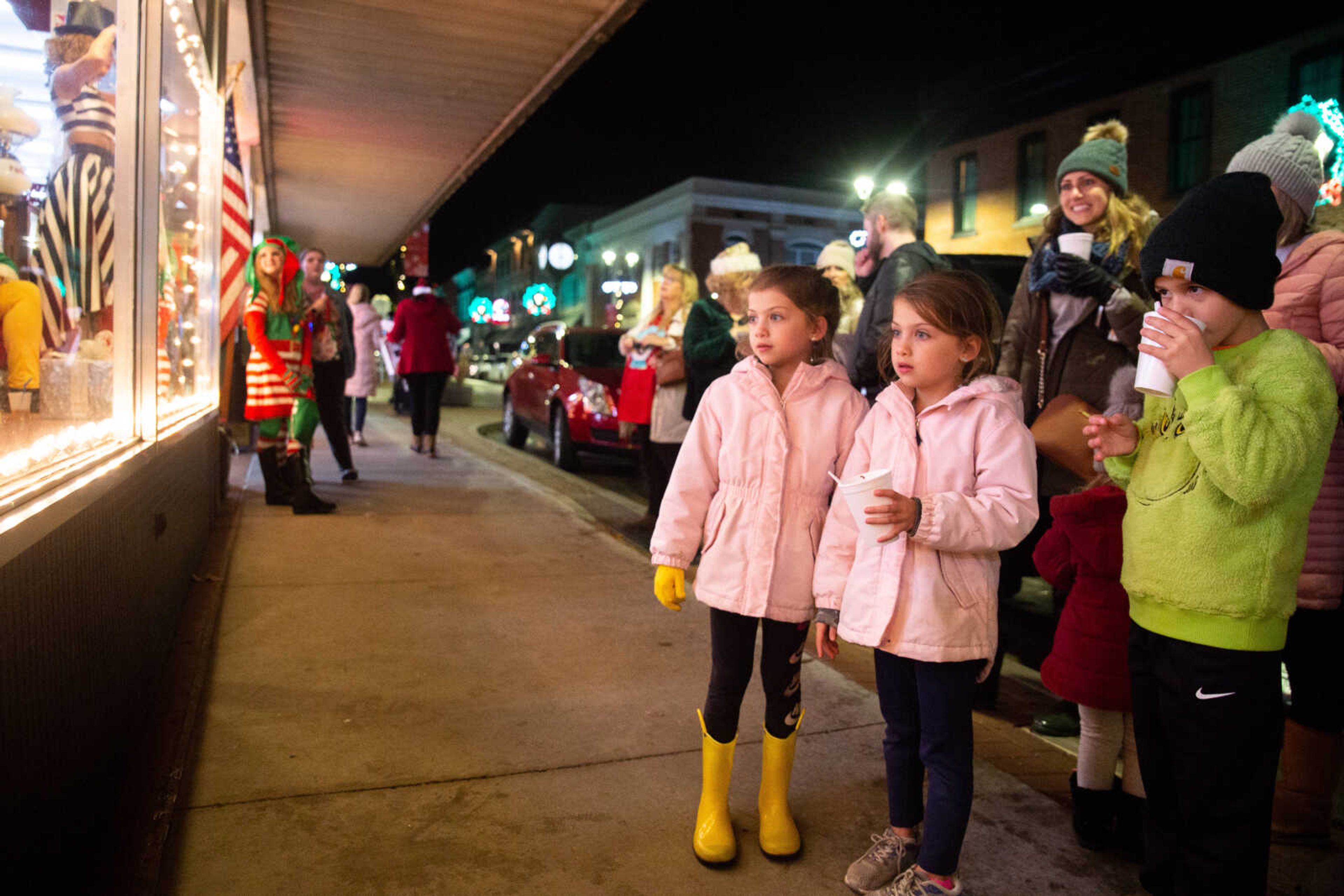 Twins Lily and Olive Carlton, 7, and Charlie Dirnberger, 7, peer into the Pastimes Antiques store windows&nbsp;on Friday, Dec. 2 in downtown Cape Girardeau.