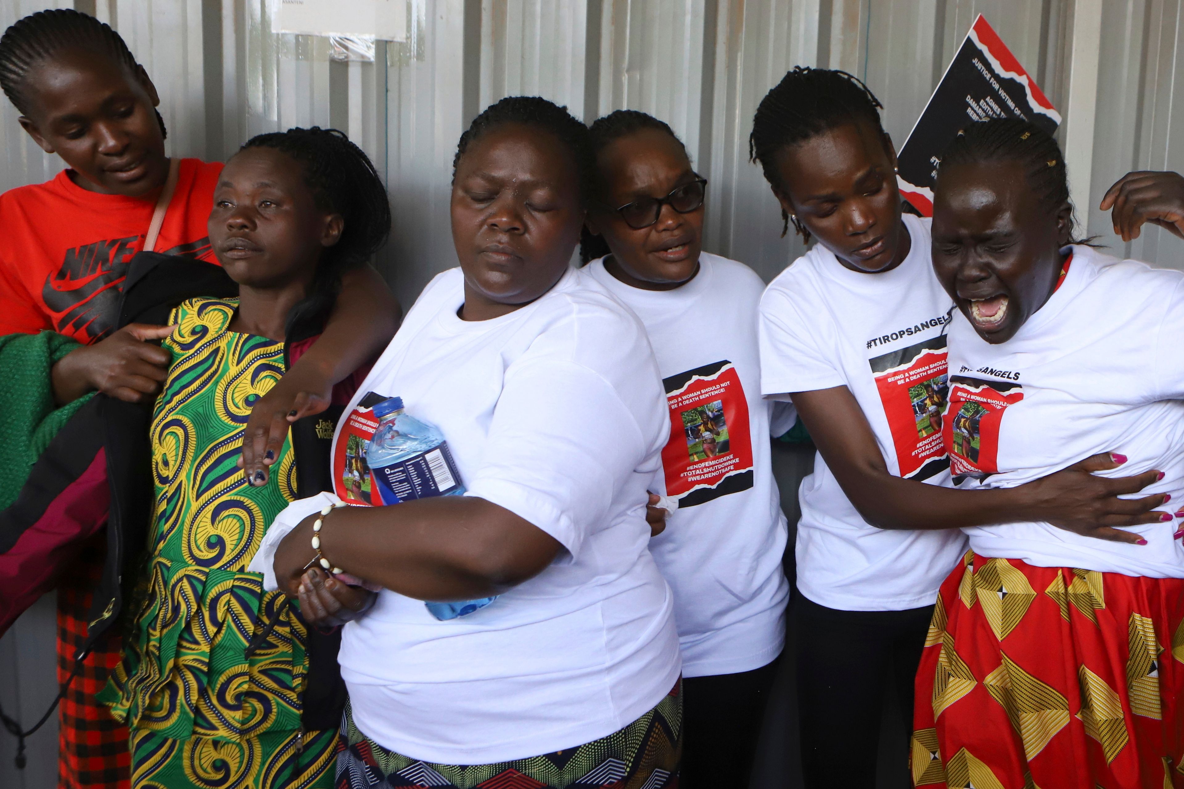 Relatives try to comfort a woman crying after viewing the body of Ugandan Olympic athlete Rebecca Cheptegei at Moi Teaching and Referral Hospital morgue in the western city of Eldoret, in Rift Valley, Kenya Friday, Sept. 13, 2024. (AP Photo/Andrew Kasuku)