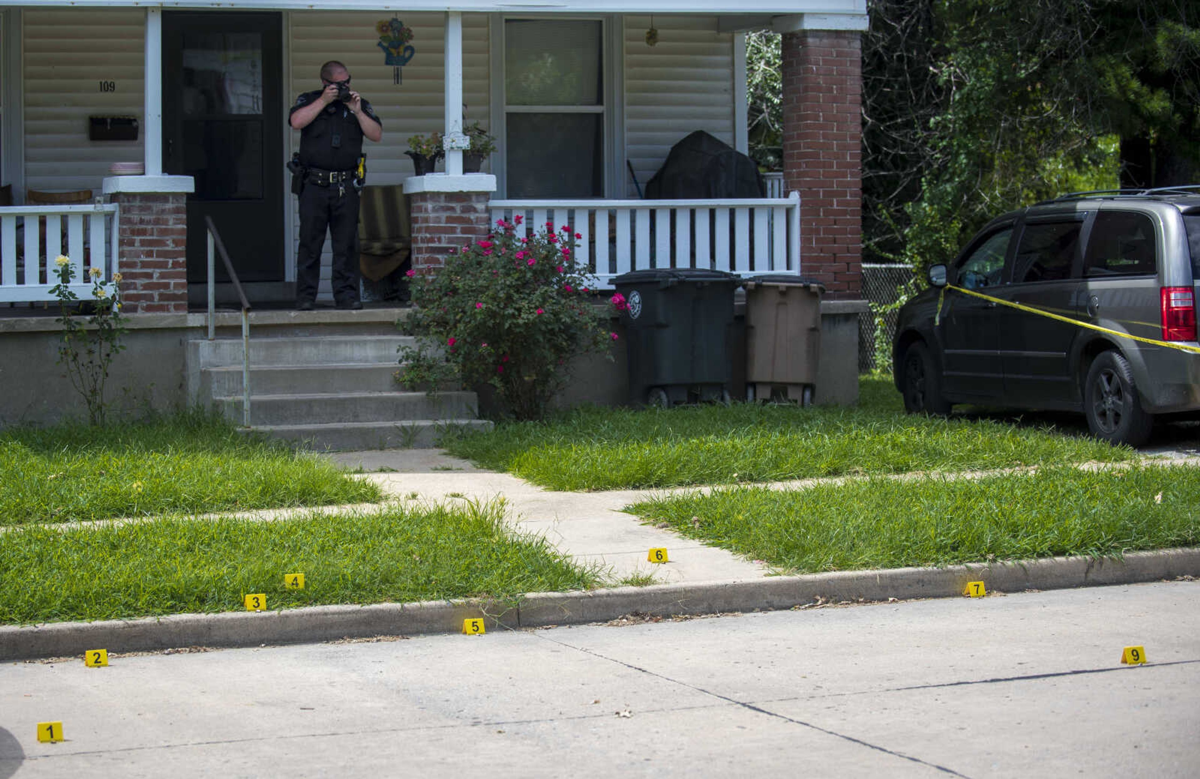 Markers identify pieces of evidence, including several shell casings, as Cape Girardeau Police investigate a shooting Monday in the 100 block of South Park Avenue.