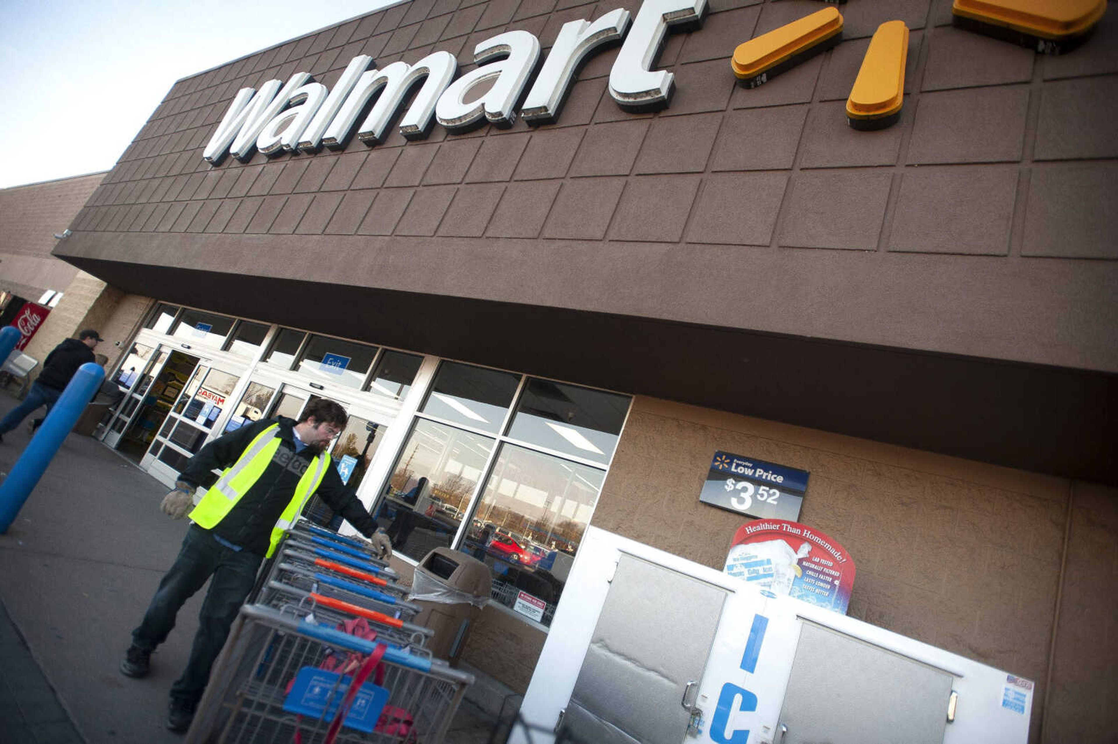 Walmart employee Nick Palen of Cape Girardeau tends to shopping carts Tuesday at the Walmart along East Jackson Boulevard in Jackson. Now open 24-hours a day, the store will close from 1 to 6 a.m. daily starting Feb. 1.