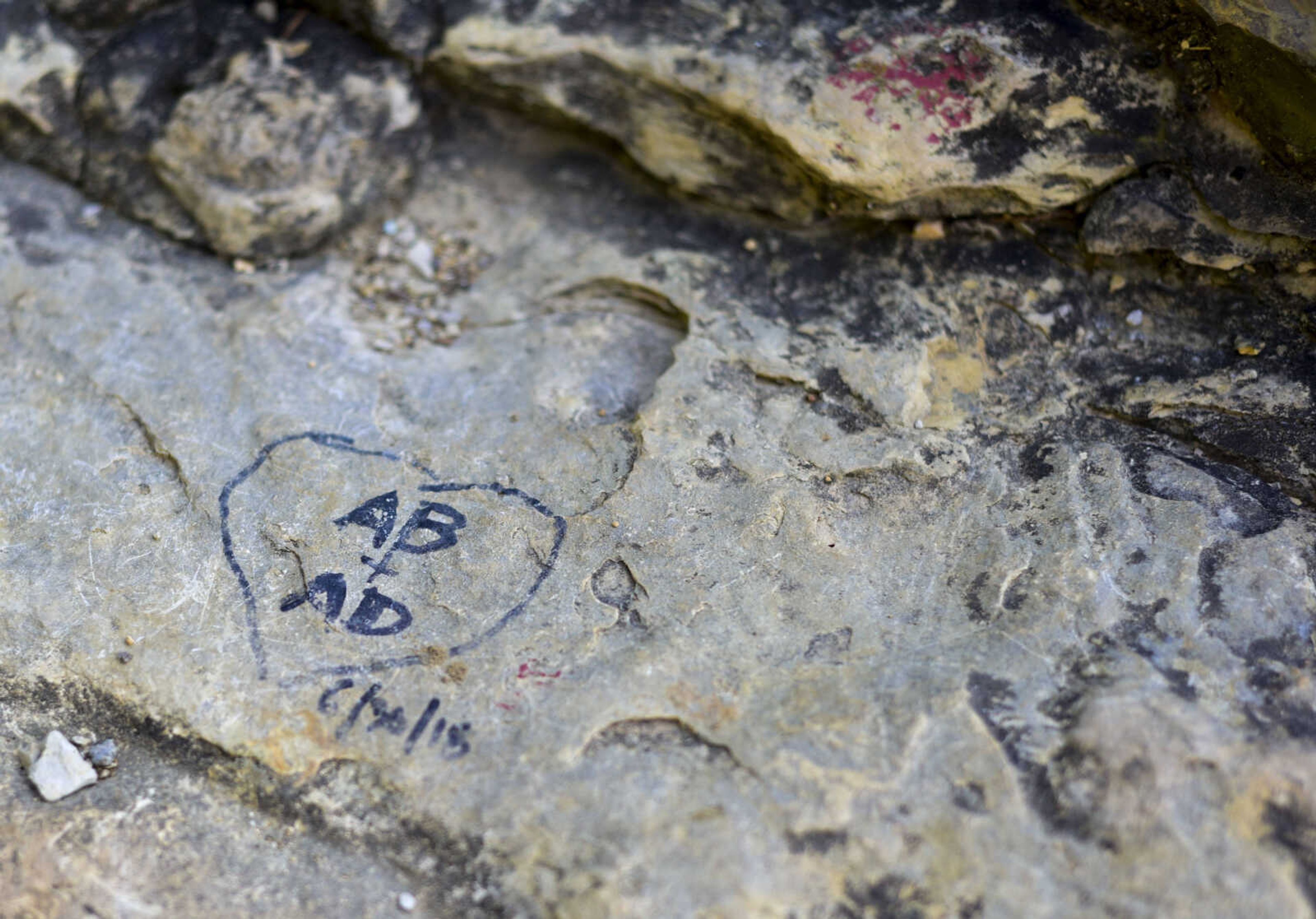 Initials etched inside of a heart are seen on the overlook at Inspiration Point on Wednesday, Aug. 1, 2018, near Wolf Lake, Illinois.