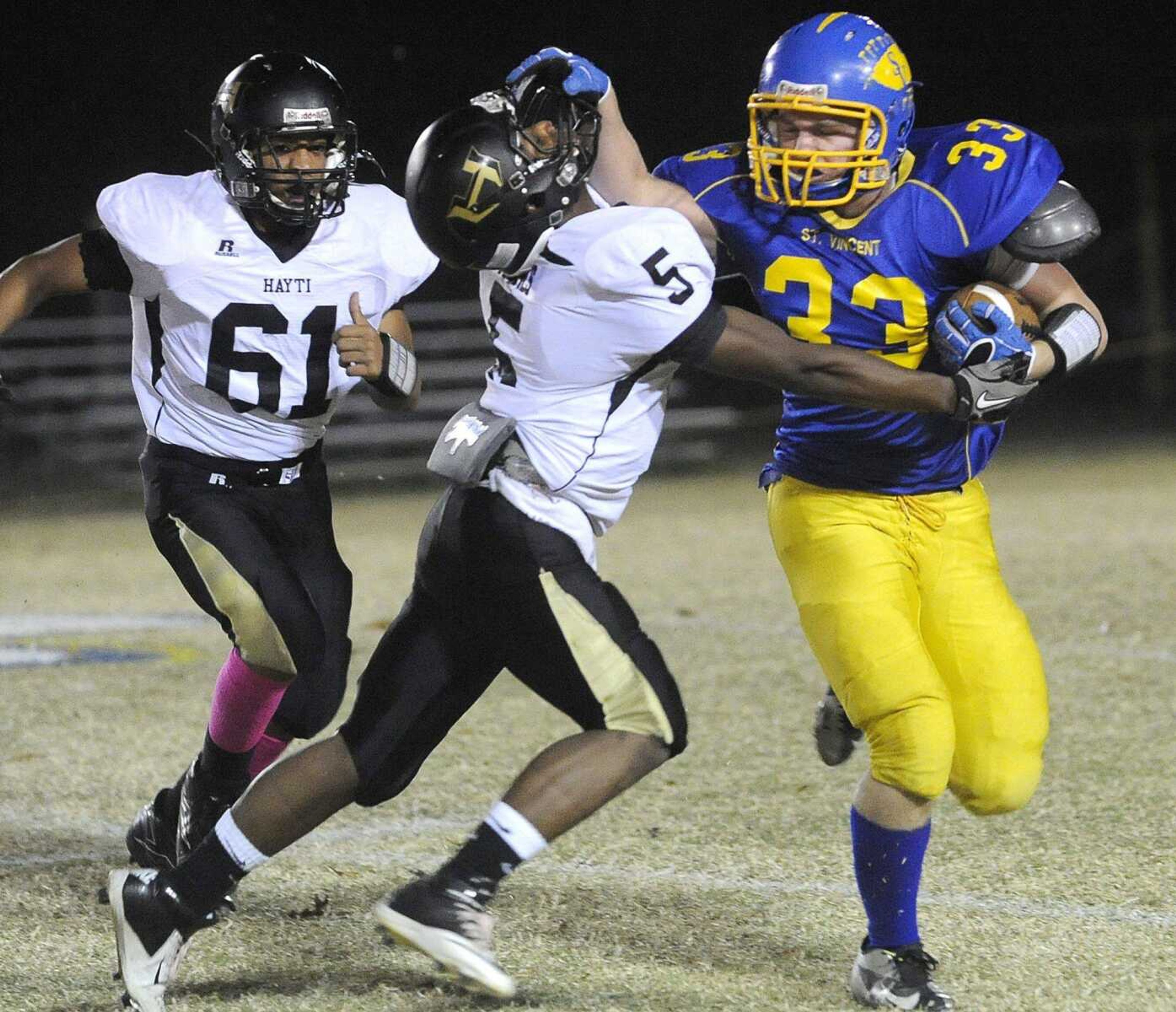 St. Vincent&#8217;s Levi Gotto stiff-arms Hayti&#8217;s Karnard Humes during the first quarter of their Class 1 District 1 game Thursday in Perryville, Mo. (Fred Lynch)