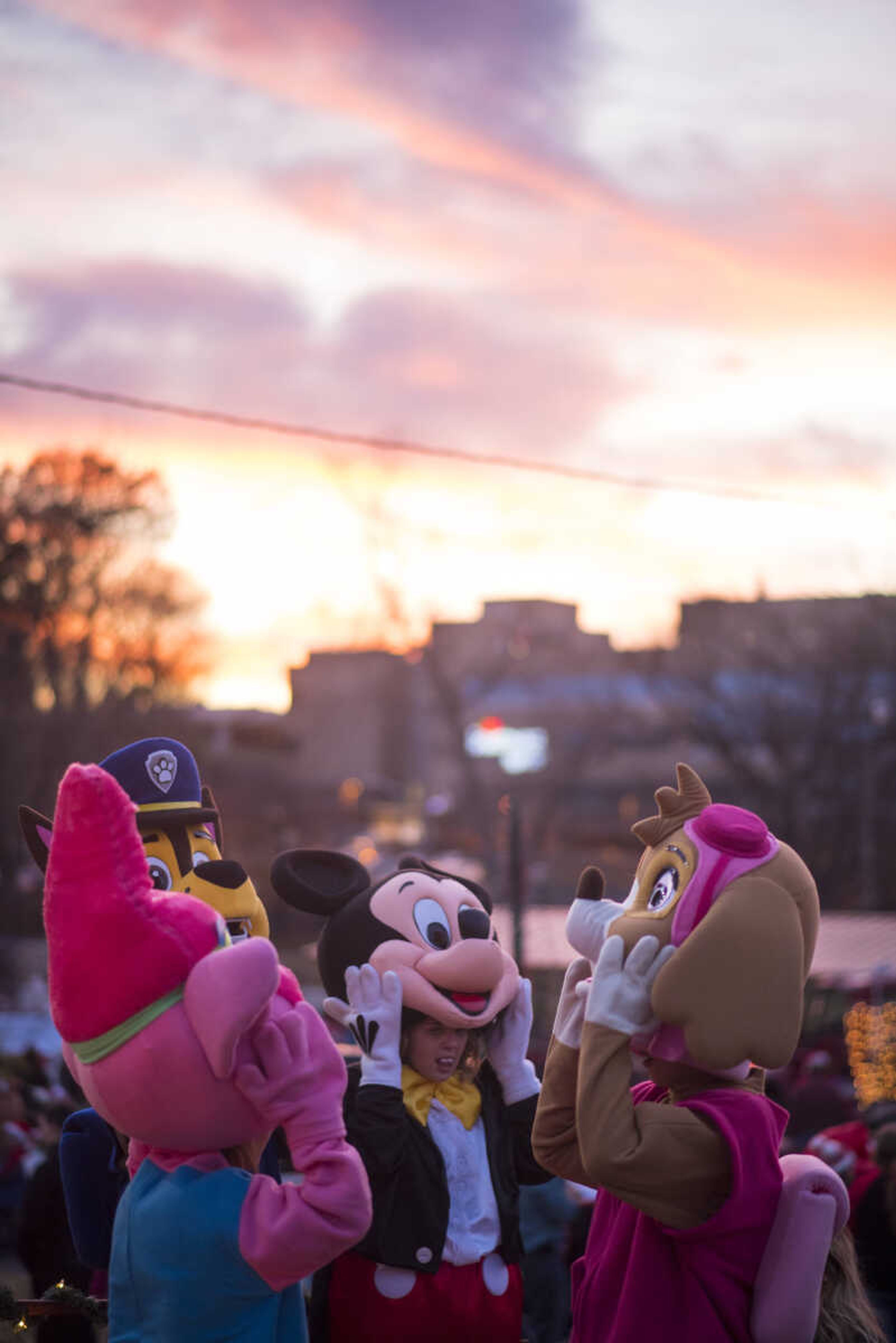 A group of mascots unmask to take a breath at Capaha Park before the start of the Parade of Lights on Nov. 26, 2017, in Cape Girardeau.