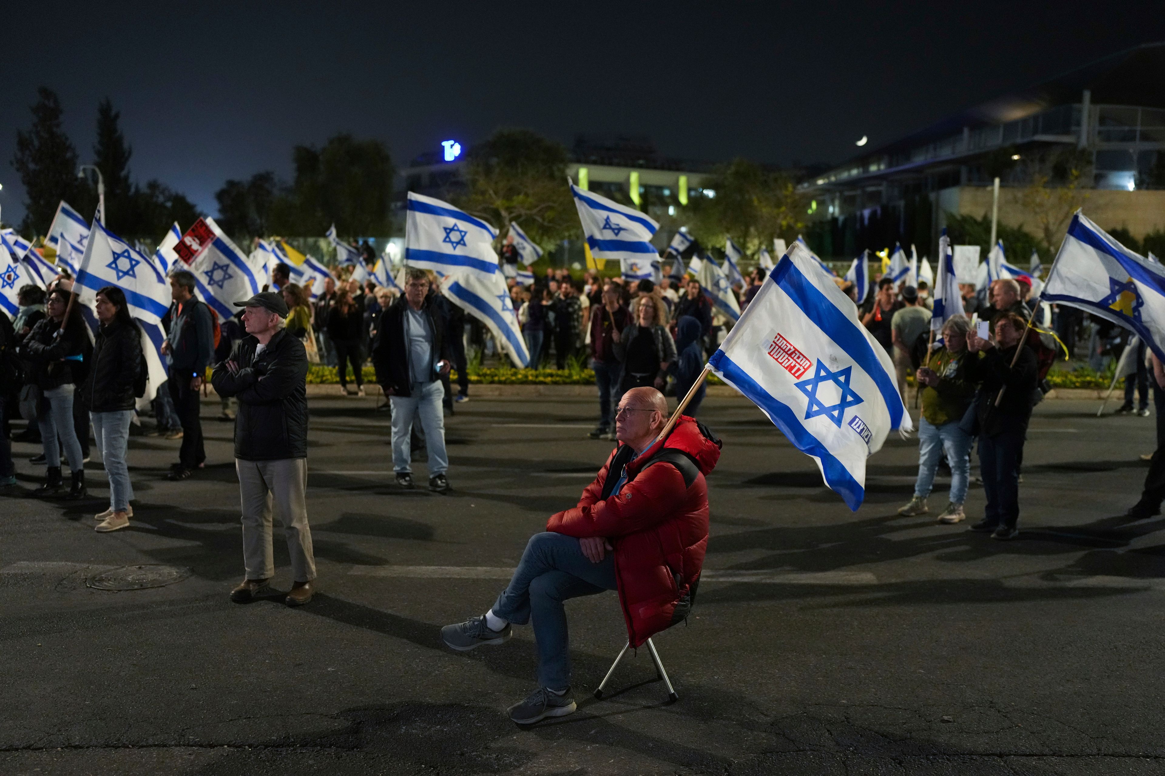 People protest against Prime Minister Benjamin Netanyahu a day after he dismissed his defence minister Yoav Gallant, near the Knesset, Israel's parliament in Jerusalem, Wednesday, Nov. 6, 2024. (AP Photo/Ohad Zwigenberg)