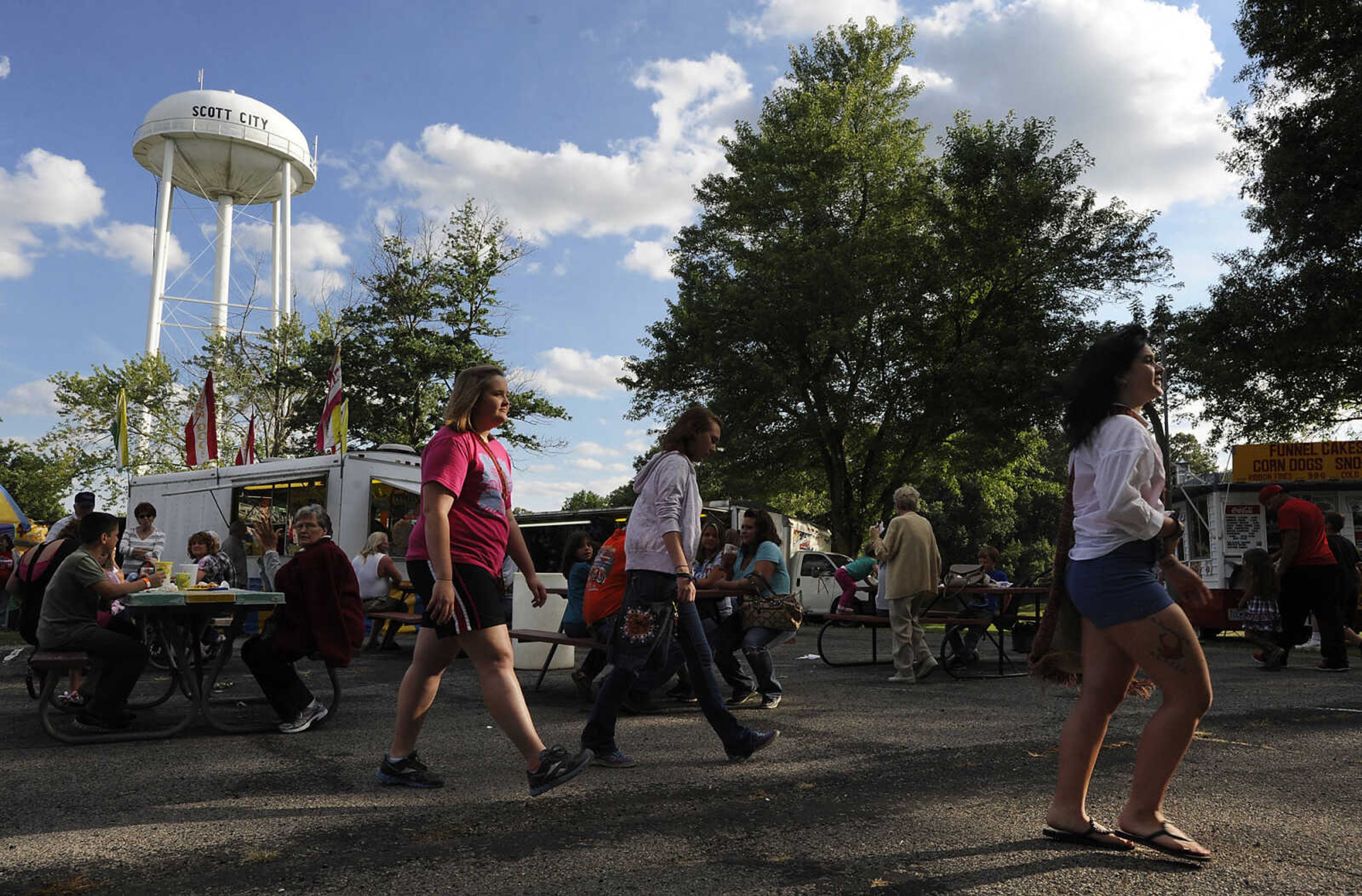 Attendees walk through the fair grounds at the 36th annual Scott City Summerfest Friday, June 1, at Scott City Park.