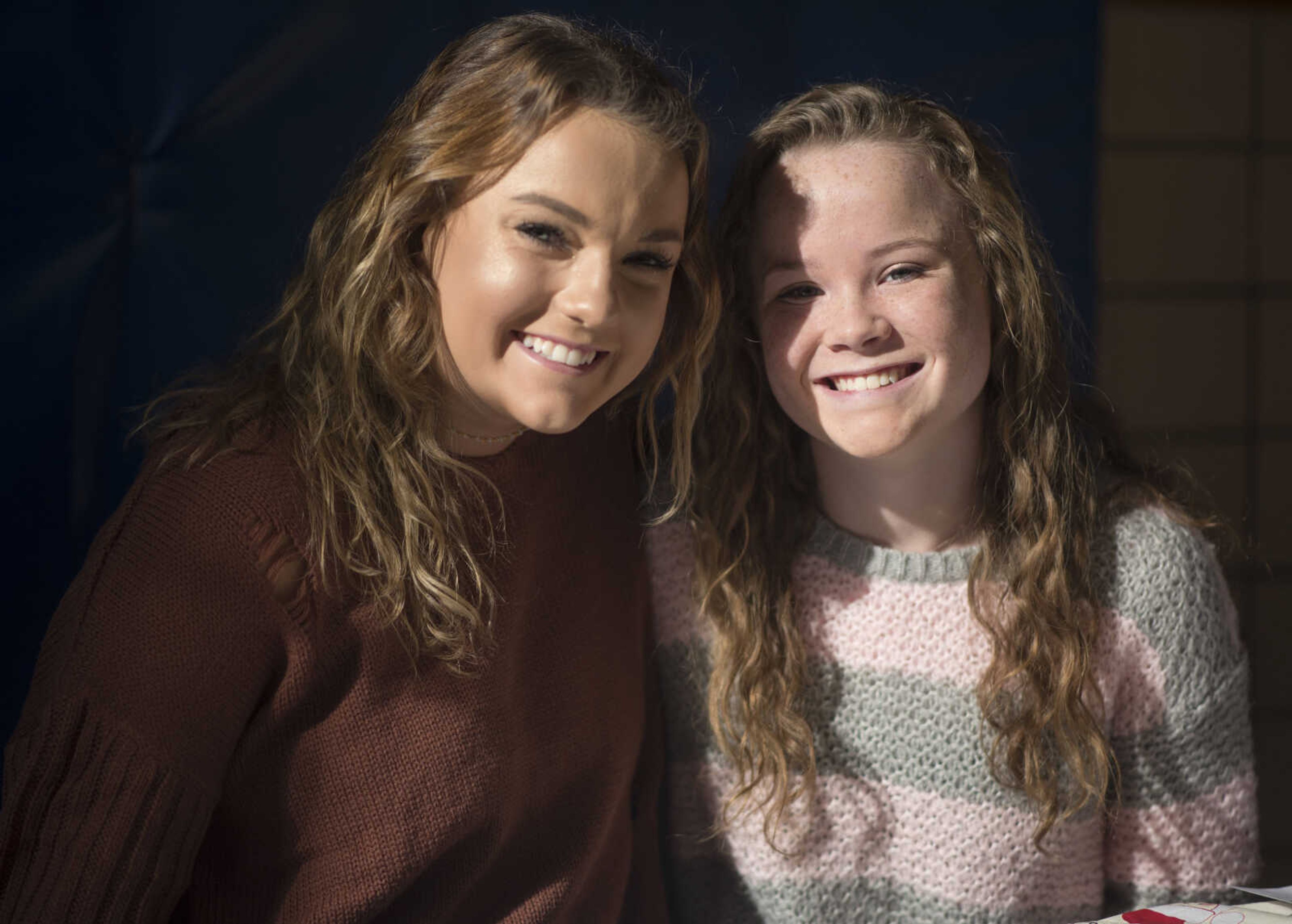 Caroline Bowen, 16, left, and Caroline Lochmann, 14, pose for a photo during a free lunch hosted by Student Santas on Dec. 25, 2017, at Jefferson Elementary School in Cape Girardeau.