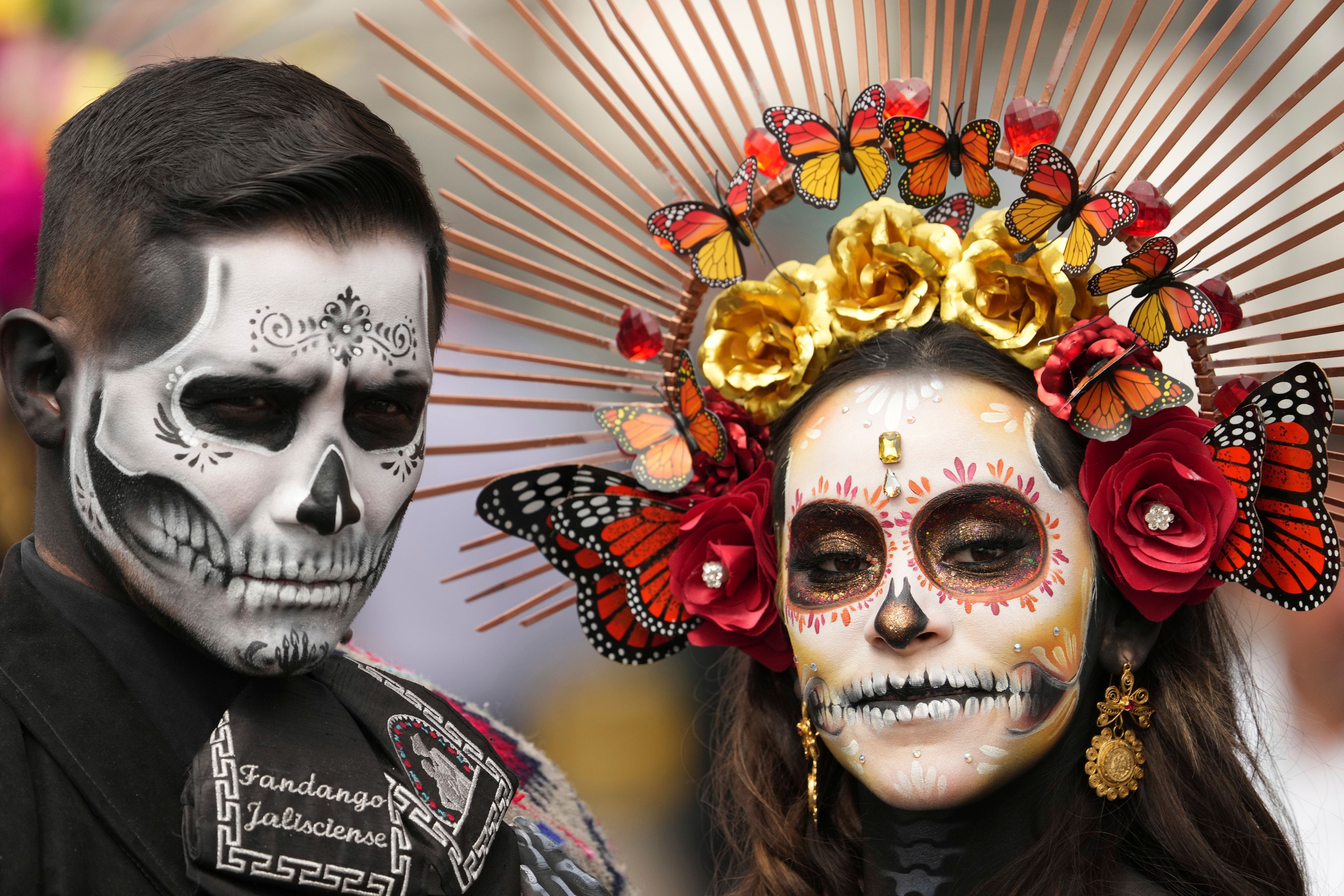 Actors dressed in Day of the Dead costumes welcome drivers at the Hermanos Rodriguez racetrack one day ahead of the Formula One Mexico Grand Prix, in Mexico City, Saturday, Oct. 26, 2024. (AP Photo/Fernando Llano)