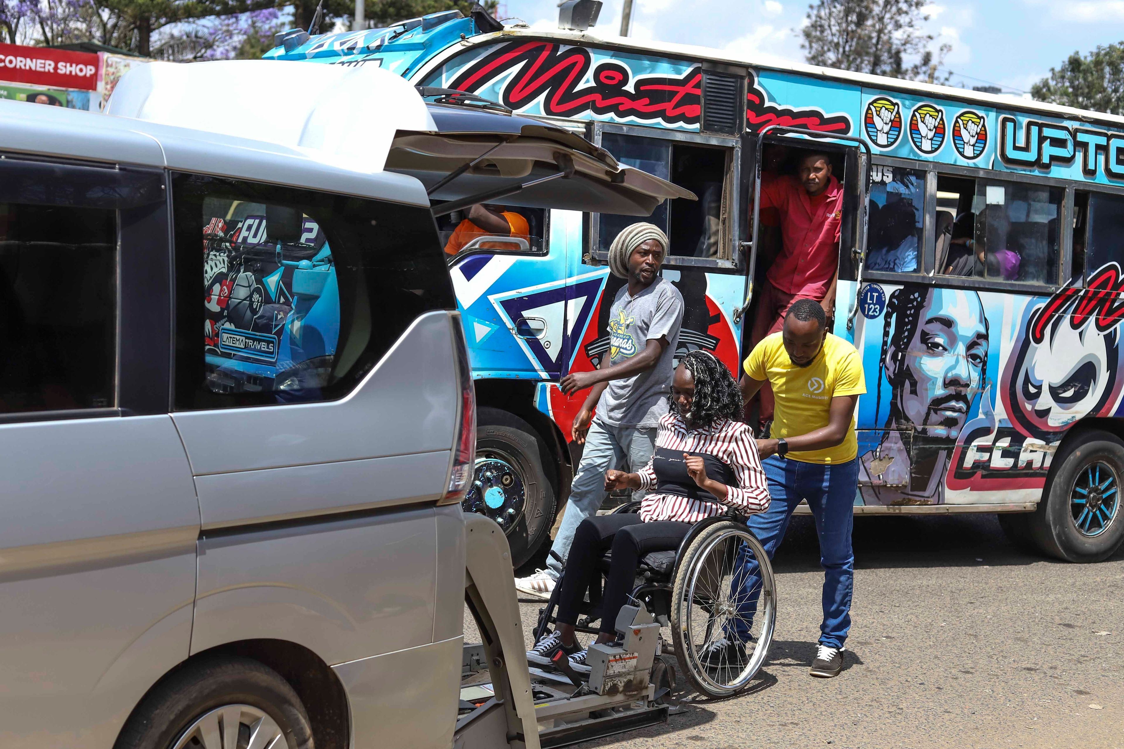 Daniel Gatura, Co-founder of Ace Mobility company, helps Carol Mwikali to get inside an Ace Mobility vehicle in Nairobi, Kenya, Wednesday, Oct. 9, 2024. (AP Photo/Andrew Kasuku)