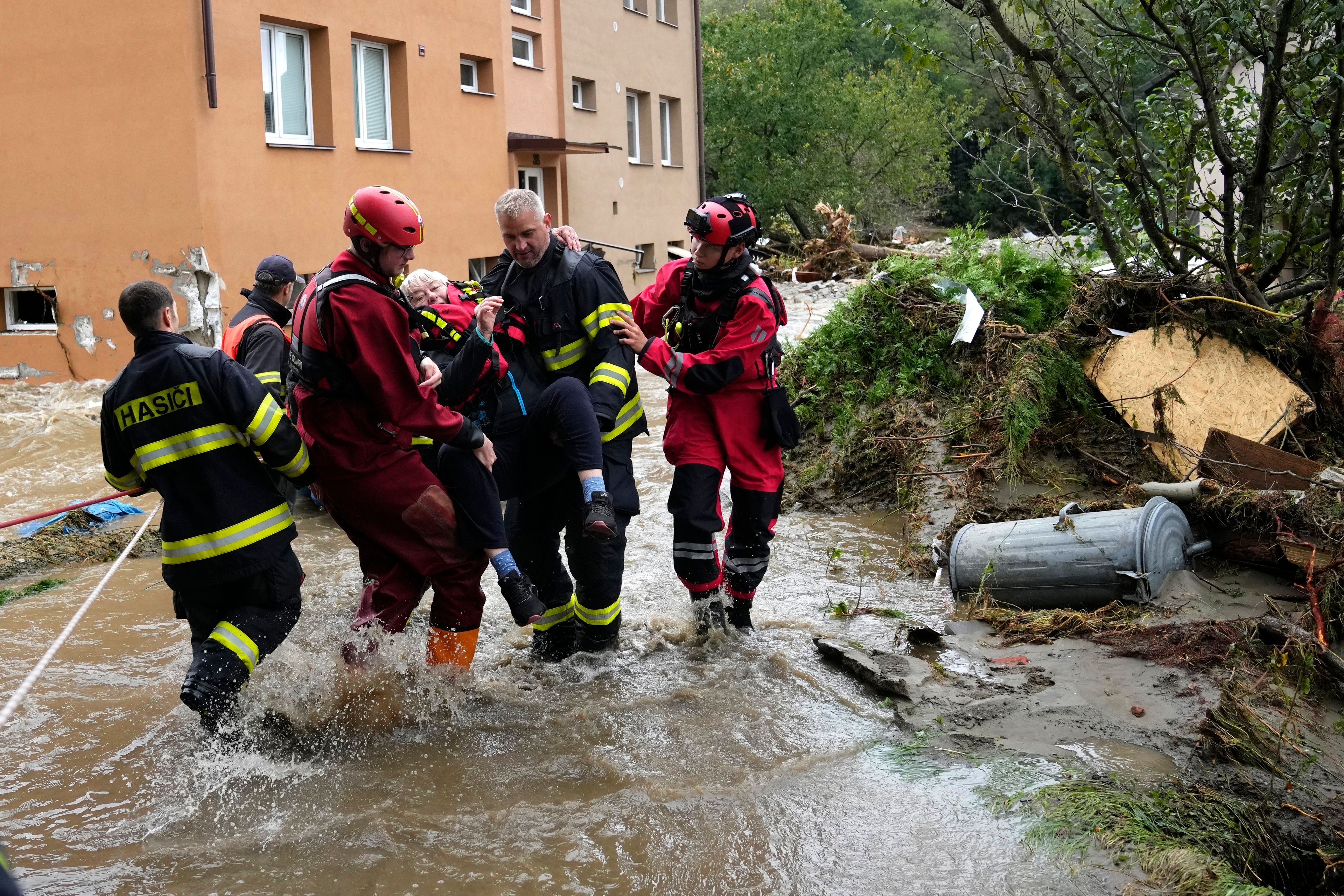 FILE - A resident is evacuated from her flooded house in Jesenik, Czech Republic, Sept. 15, 2024. (AP Photo/Petr David Josek, File)