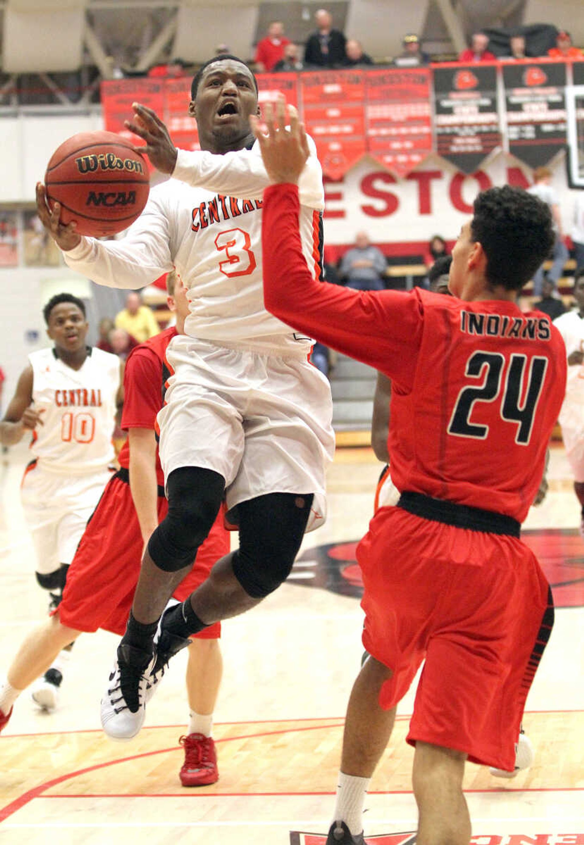 Cape Central's Al Young goes up for a shot against Jackson's Stephen Irons (24) in the consolation finals of the SEMO Conference Tournament on Friday night at the Sikeston Field House. (David Jenkins/Standard Democrat)