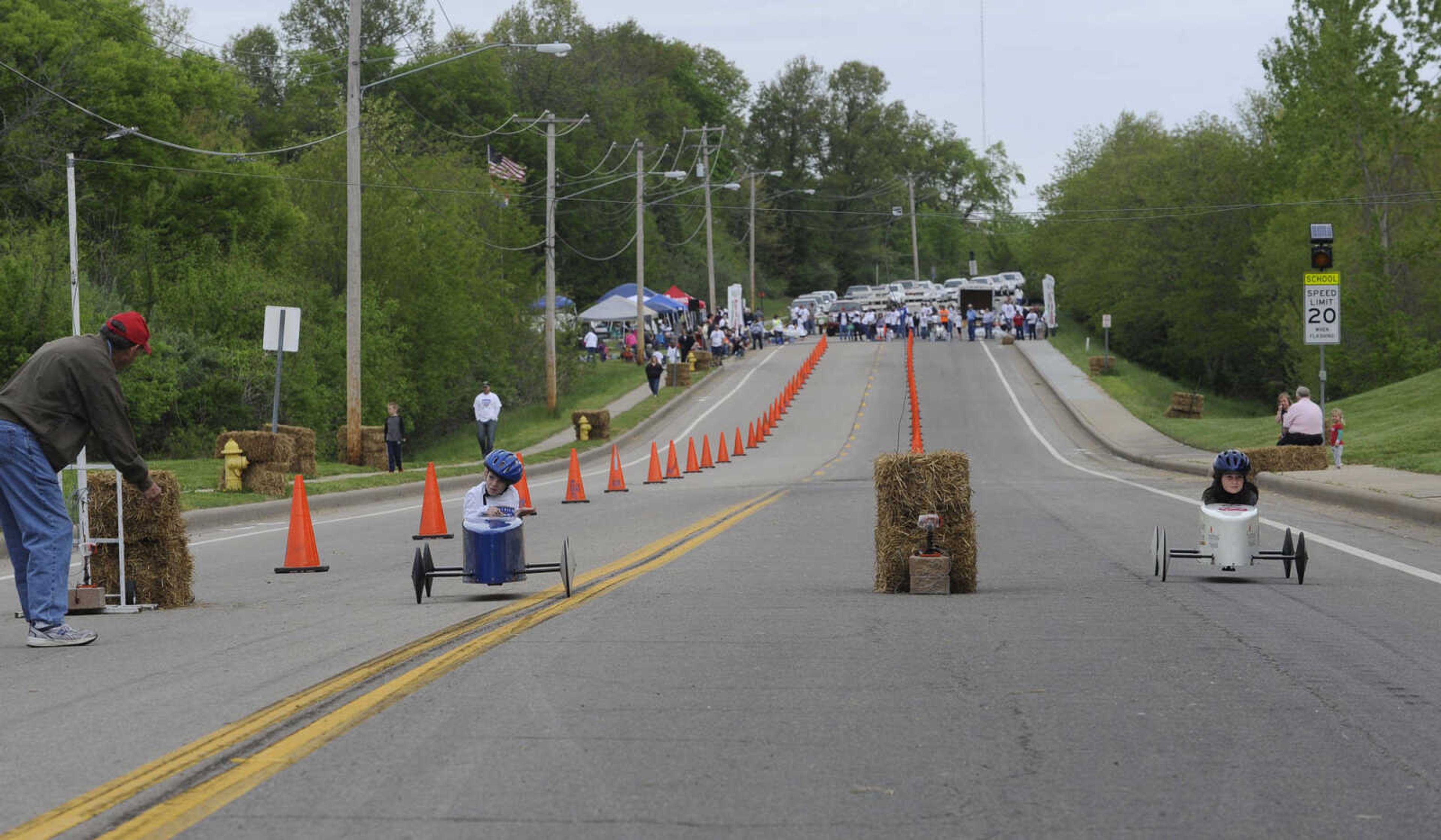 Connor Kennard, left, and Emma Wilson finish a race during the Soap Box Derby sponsored by the Cape Girardeau Rotary Club on Saturday, May 3, 2014 in Cape Girardeau.