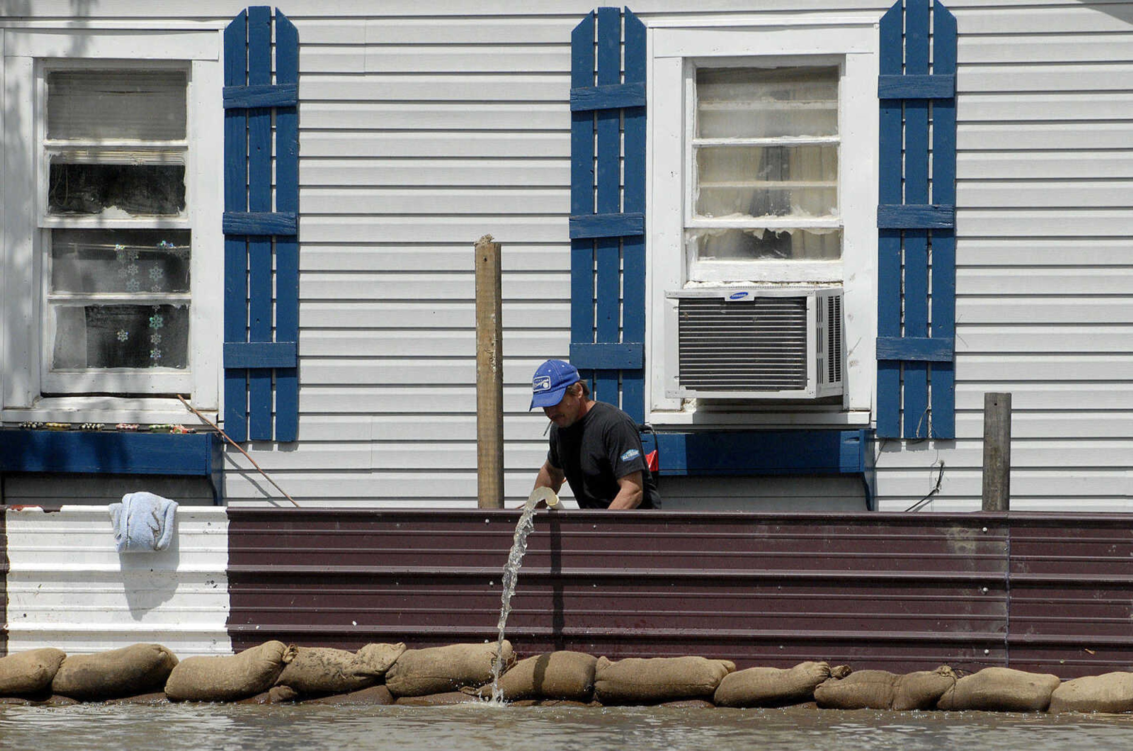 LAURA SIMON~lsimon@semissourian.com
Bill Sanquist checks his water pump outside his home on Main Street Thursday, April 28, 2011 in Cape Girardeau.