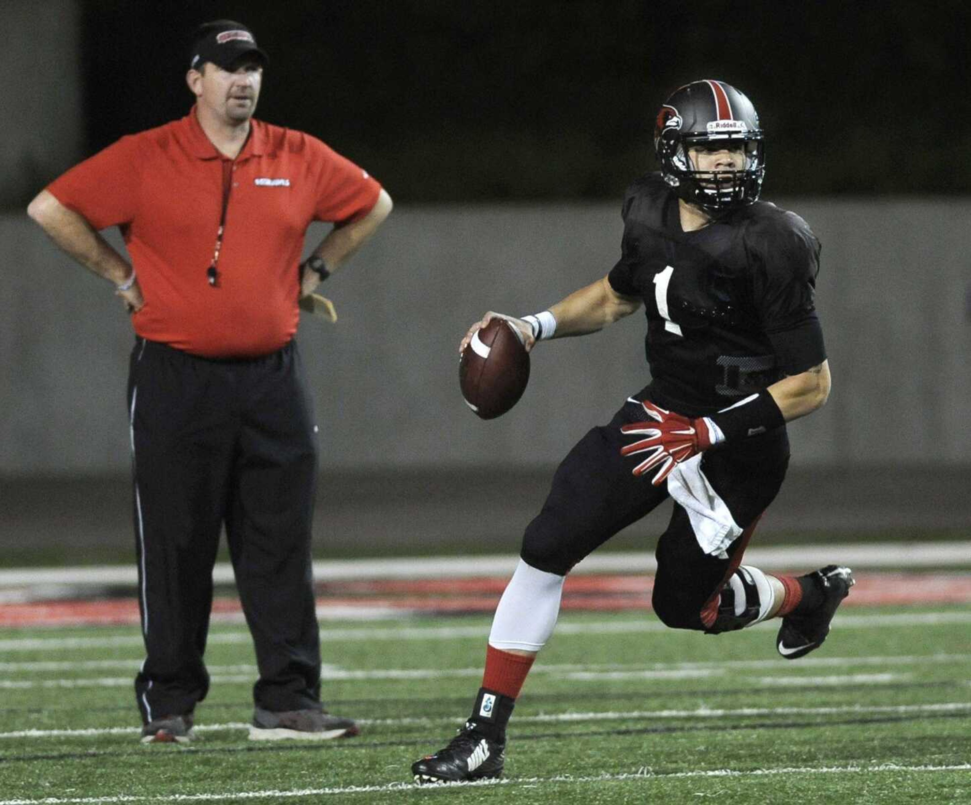 Southeast Missouri State quarterback Tay Bender looks for a receiver as coach Tom Matukewicz looks on during the spring game Friday, April 17, 2015 at Houck Stadium. (Fred Lynch)