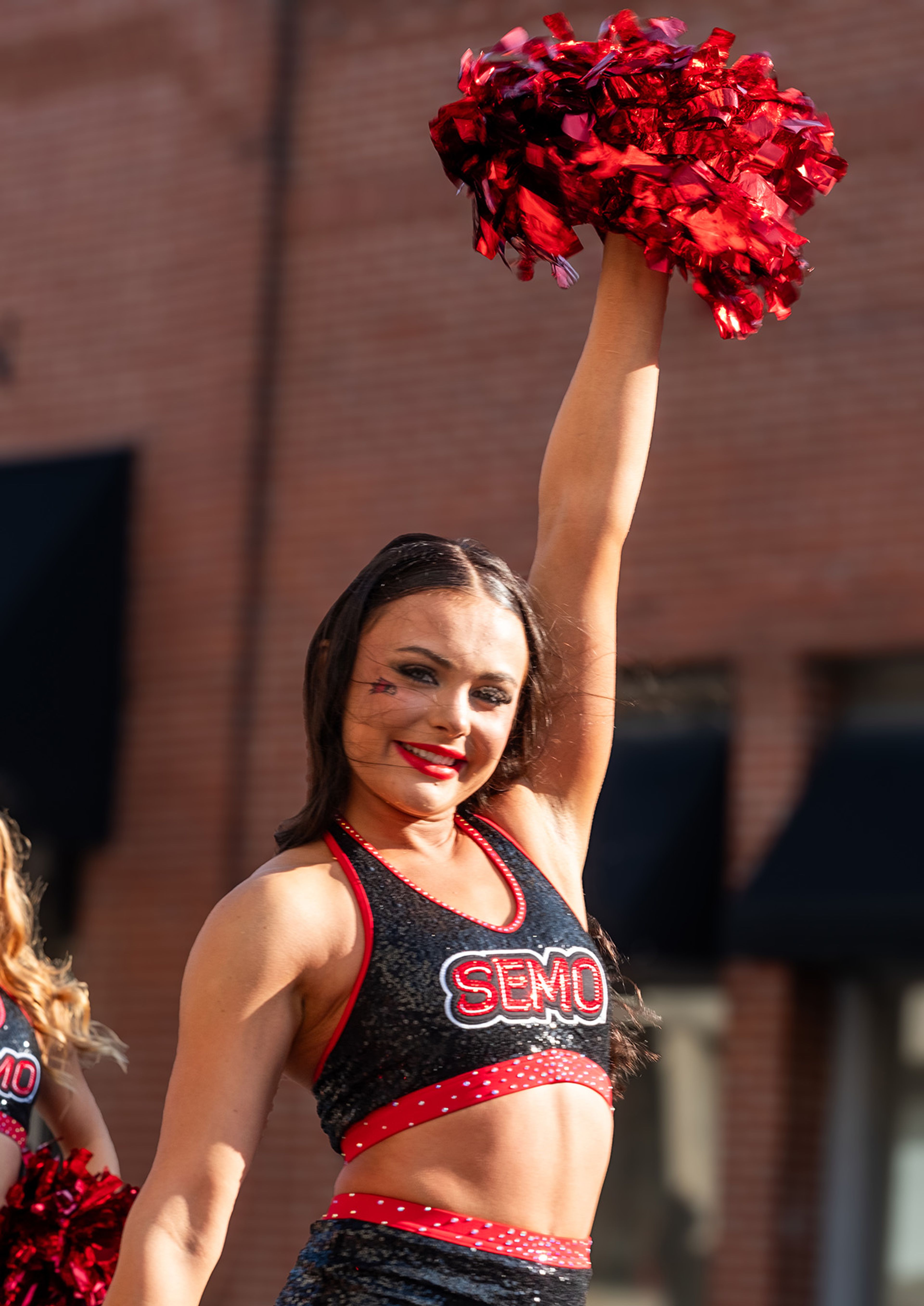 SEMO Sundancer Rachel Saferite from Chesterfield beams as she cheers in the Homecoming parade.