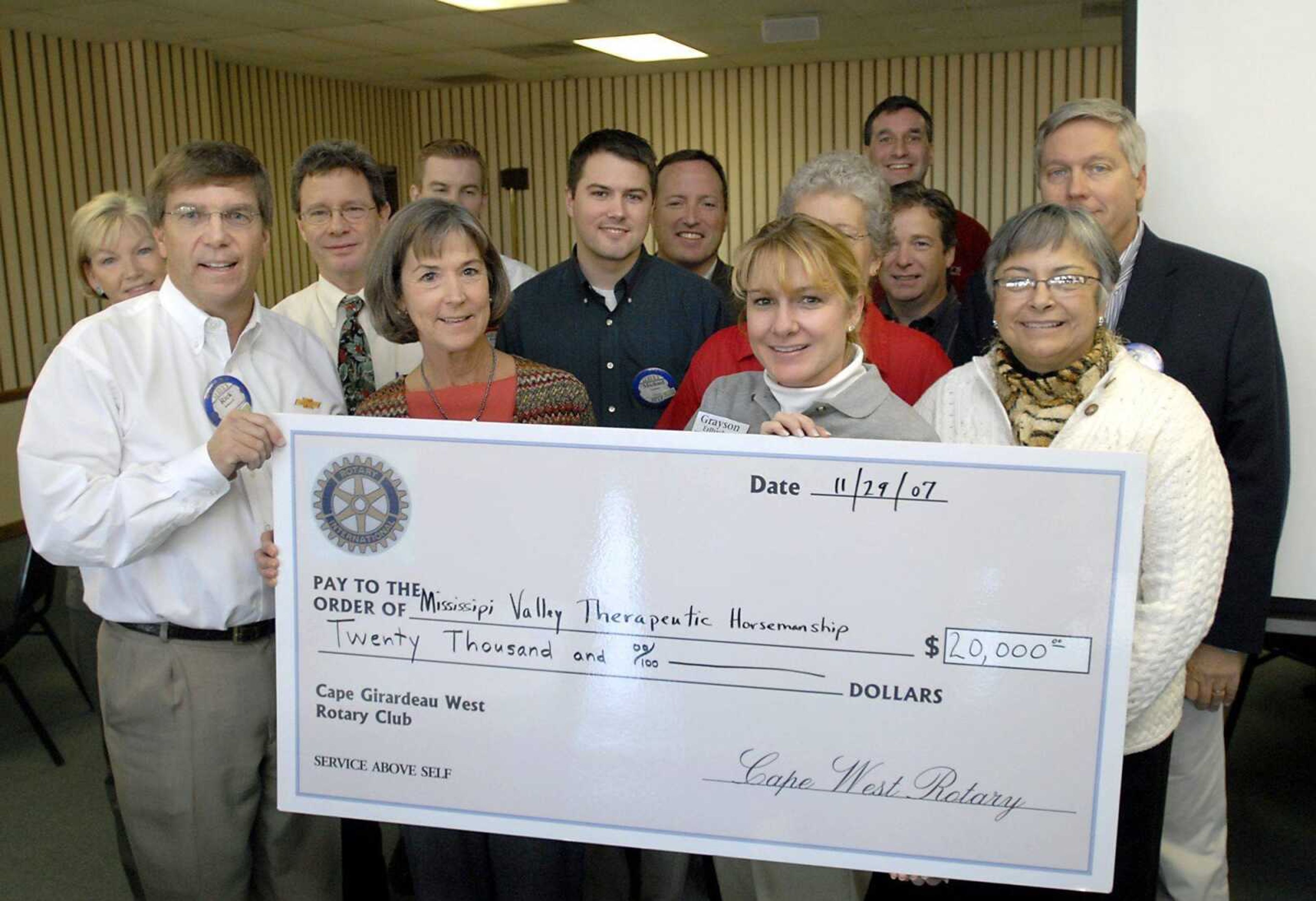 Cape West Rotary president Rick Kennard, left, presented a $20,000 check to Mississippi Valley Therapeutic Horsemanship on Thursday. The money will be used for two handicapped-accessible bathrooms and other amenities in a building near the arena, according to Betsy Rigdon, MVTH board president. (Kit Doyle)