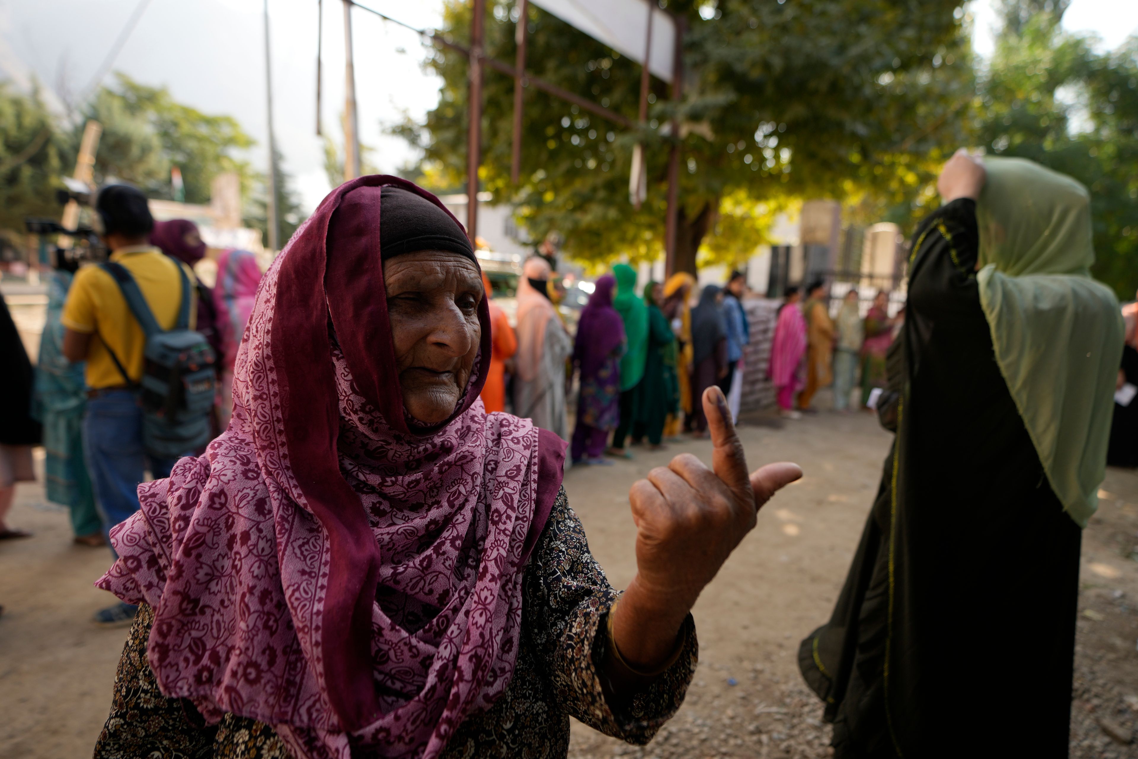 A woman shows the indelible ink mark on her finger after casting her vote during the first phase of the Jammu and Kashmir assembly election, in Kishtwar, India, Wednesday, Sept. 18, 2024. (AP Photo/Channi Anand)