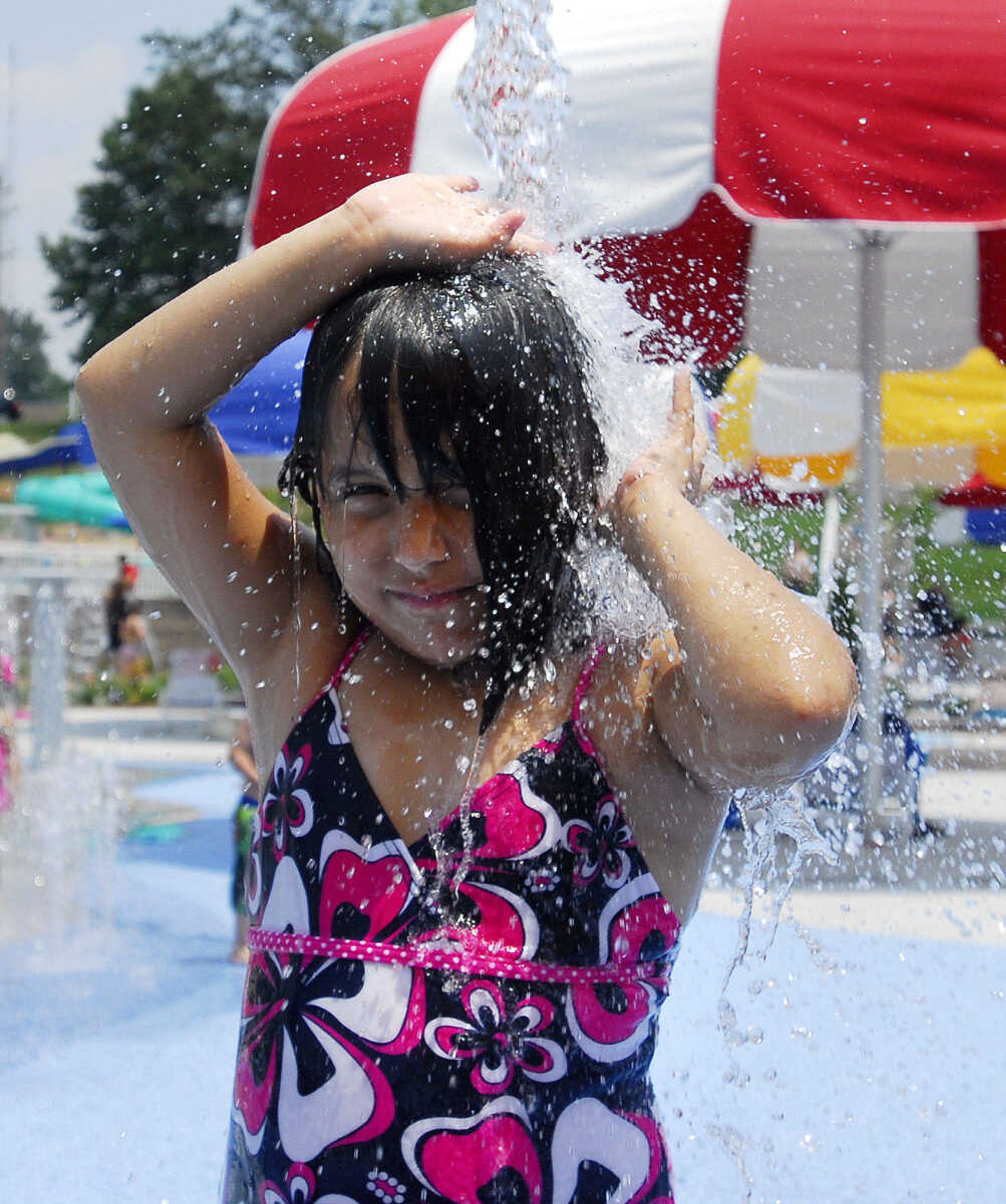 LAURA SIMON~lsimon@semissourian.com
Jacque Ventura, 6, cools off on the splash pad area Saturday, May 29, 2010 during the opening day of Cape Splash Family Auquatic Center.