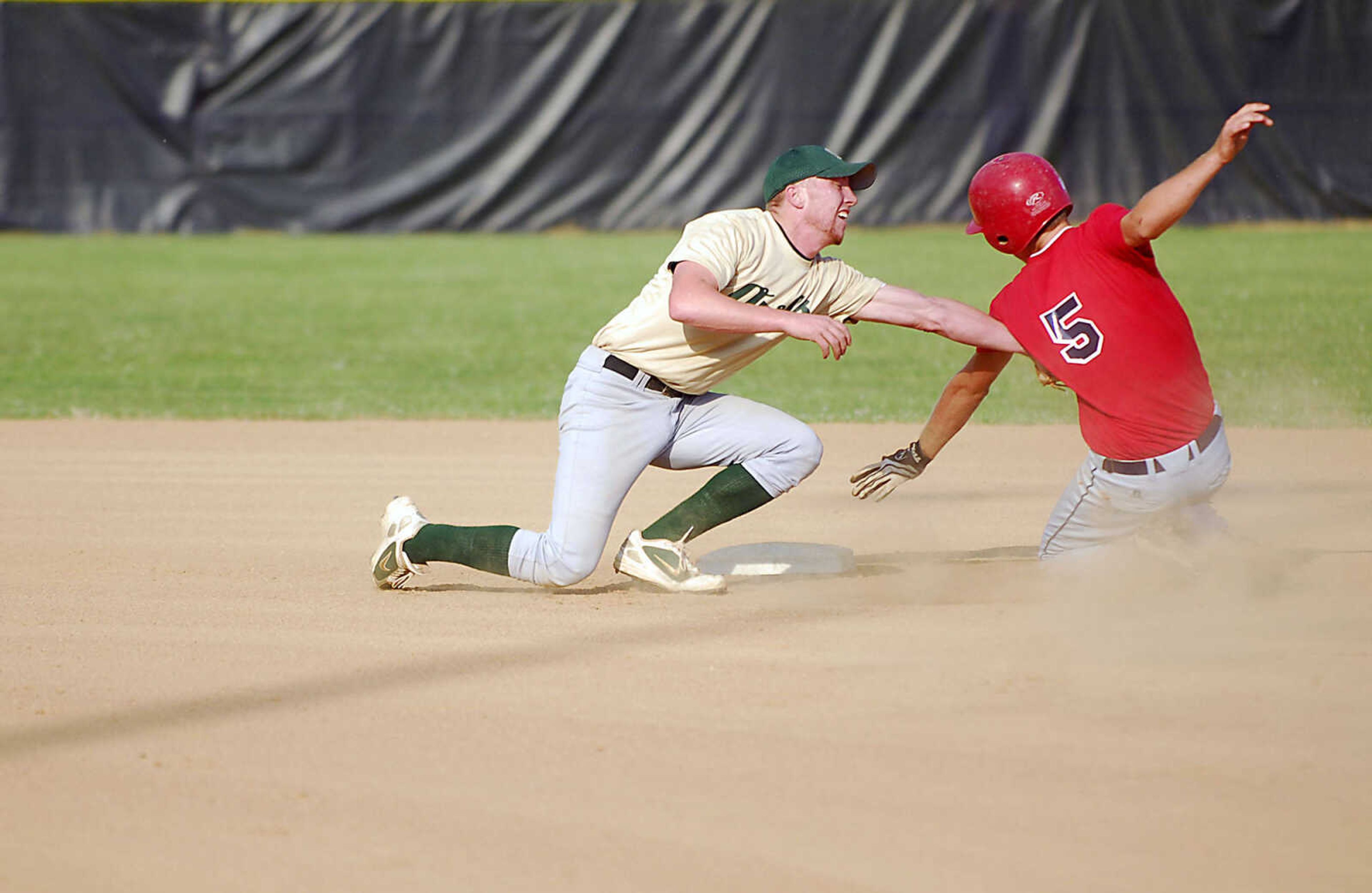 KIT DOYLE ~ kdoyle@semissourian.com
New Madrid shortstop Kyle Marshall tags out Garrett Fritsche on a steal attempt Monday evening, July 6, 2009, in a Senior Babe Ruth game at Jackson City Park.