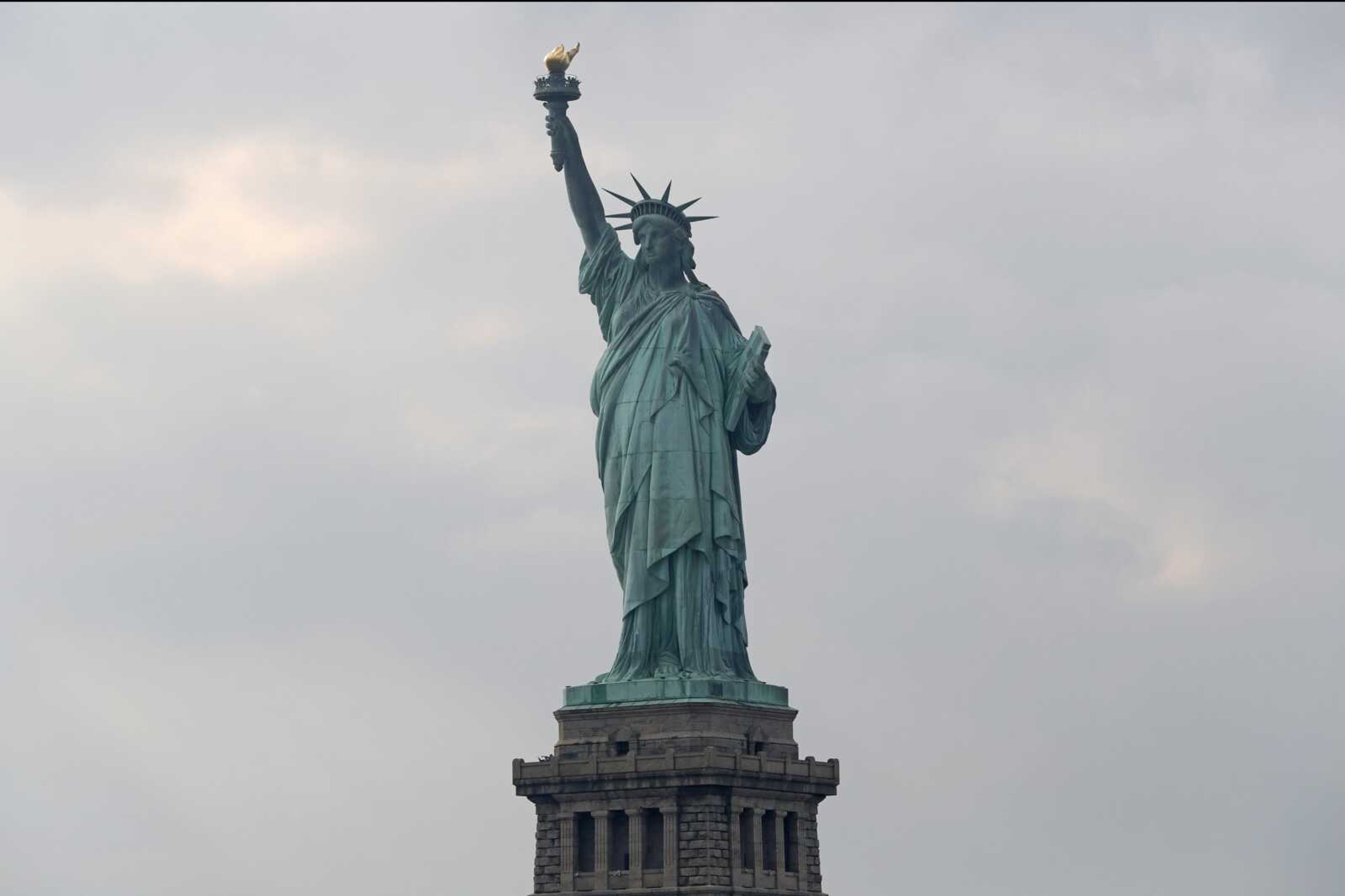 FILE - In this Aug. 14, 2019 file photo, The Statue of Liberty is shown in New York. The Department of Homeland Security says New York residents will be cut off from Â‚Ã„Ã²trusted travelerÂ‚Ã„Ã´ programs because of a state law that prevents immigration officials from accessing motor vehicle records. Acting Deputy DHS Secretary Ken Cuccinelli says tens of thousands of New Yorkers will be inconvenienced by the action.  (AP Photo/Kathy Willens)