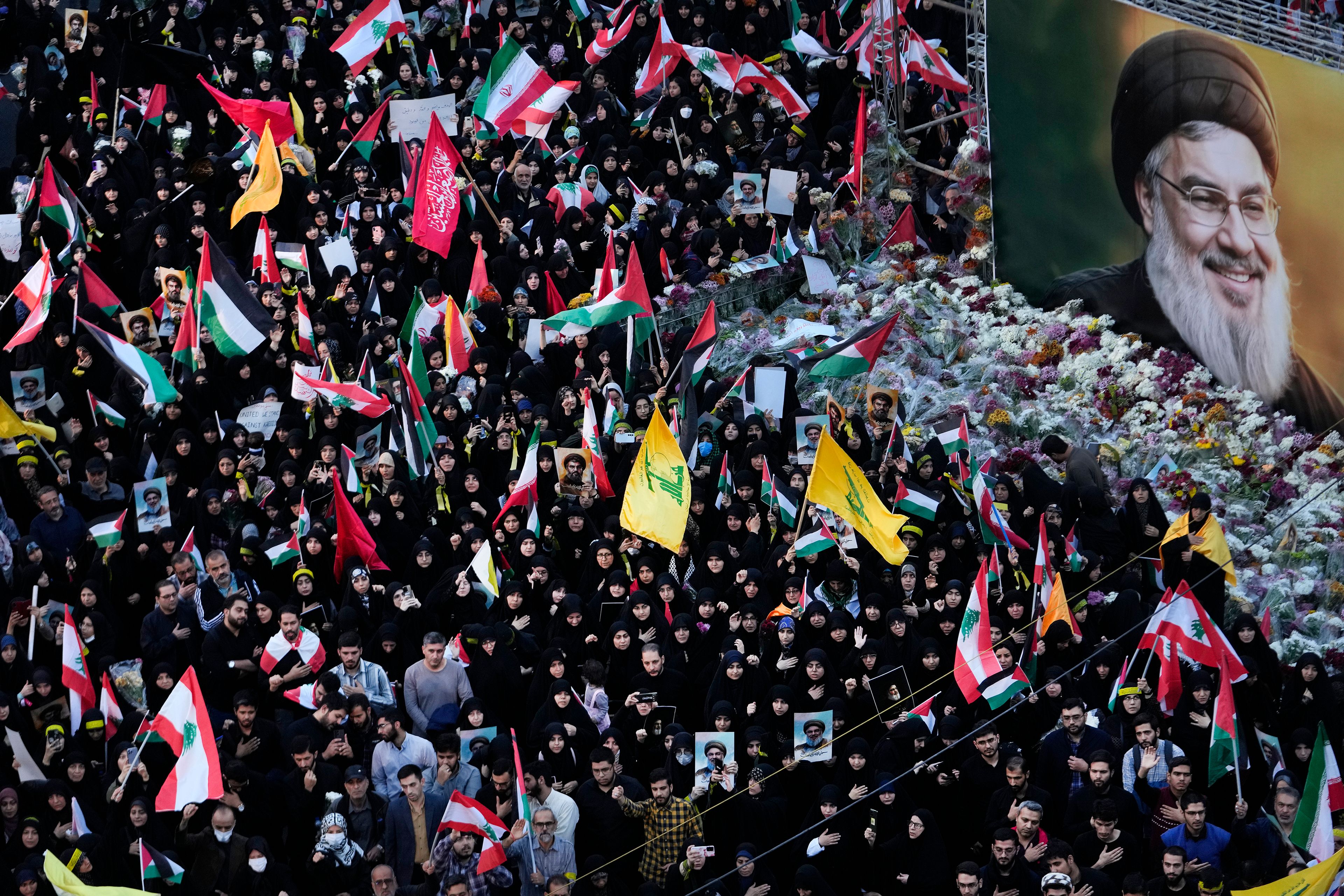 Mourners attend a rally commemorating slain Hezbollah leader Hassan Nasrallah, shown in billboard, at Felestin (Palestine) Sq. in downtown Tehran, Iran, Monday, Sept. 30, 2024. (AP Photo/Vahid Salemi)