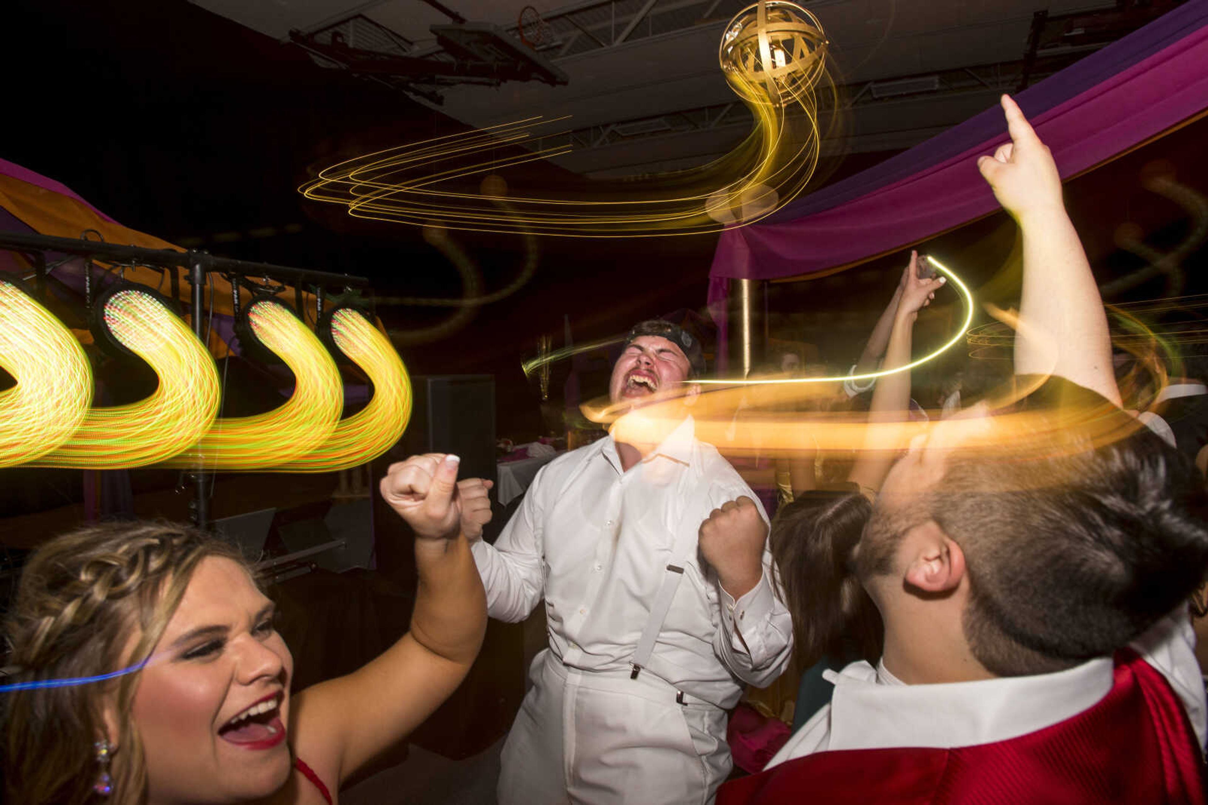 Levi Watkins, center, and other students collectively sing the high note Р "somewhere in the night" Р while dancing to Journey's "Don't Stop Believin'" during prom Saturday, April 6, 2019, at Kelly High School in Benton.