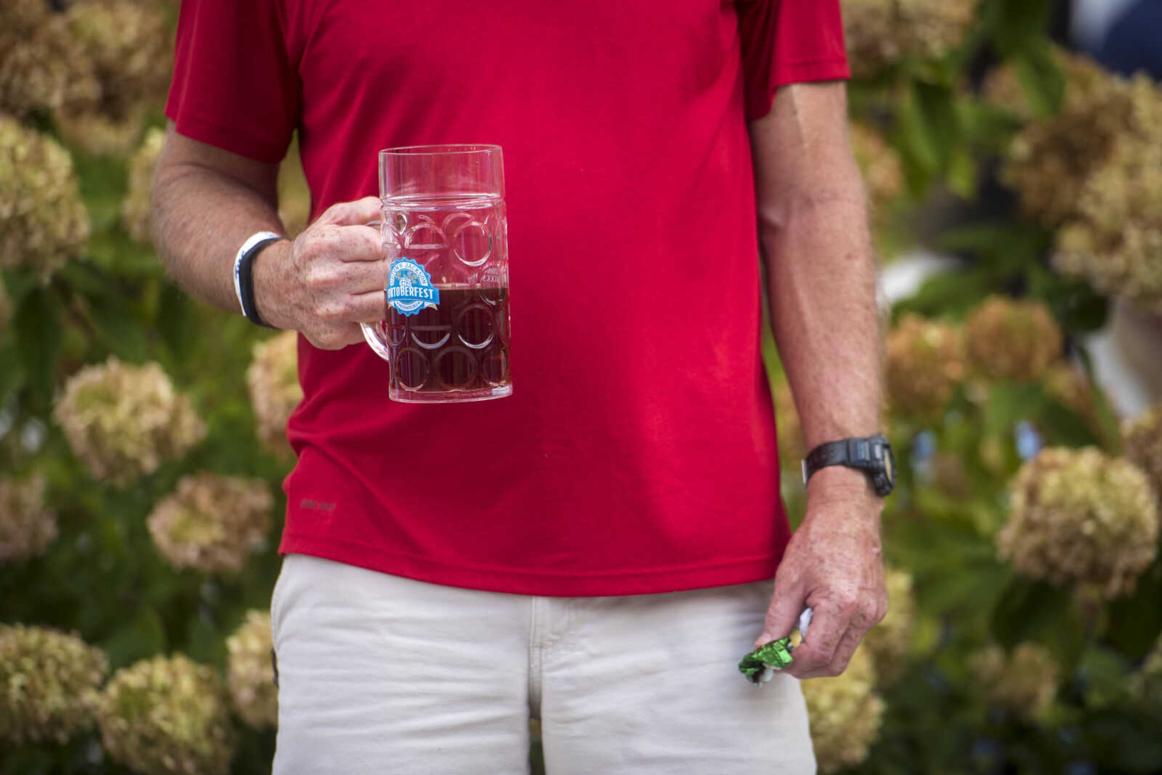 Rick Brizendine holds his Sam Adams Octoberfest beer at the Uptown Jackson Oktoberfest, Saturday, October 7, 2017.