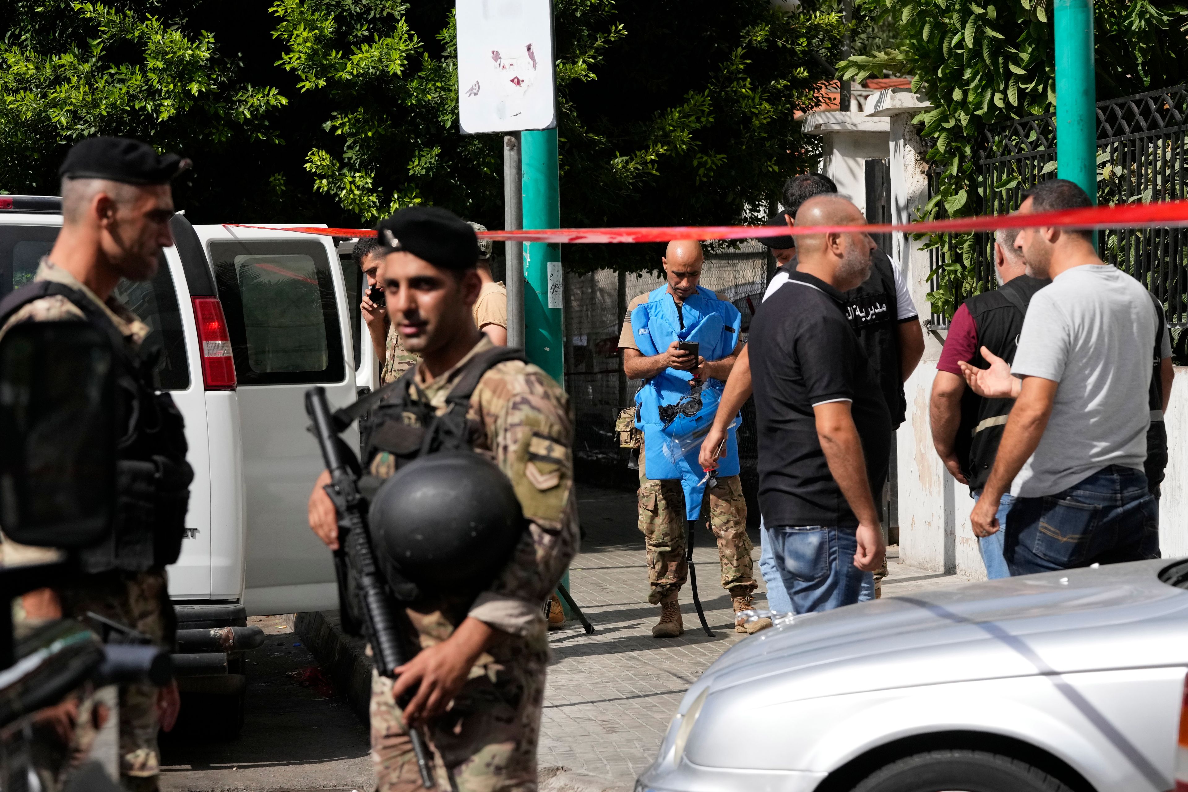 Police tape cordons off the area as security members and an explosive specialist investigate a suspicious device in Beirut, Thursday, Sept. 19, 2024. (AP Photo/Hassan Ammar)