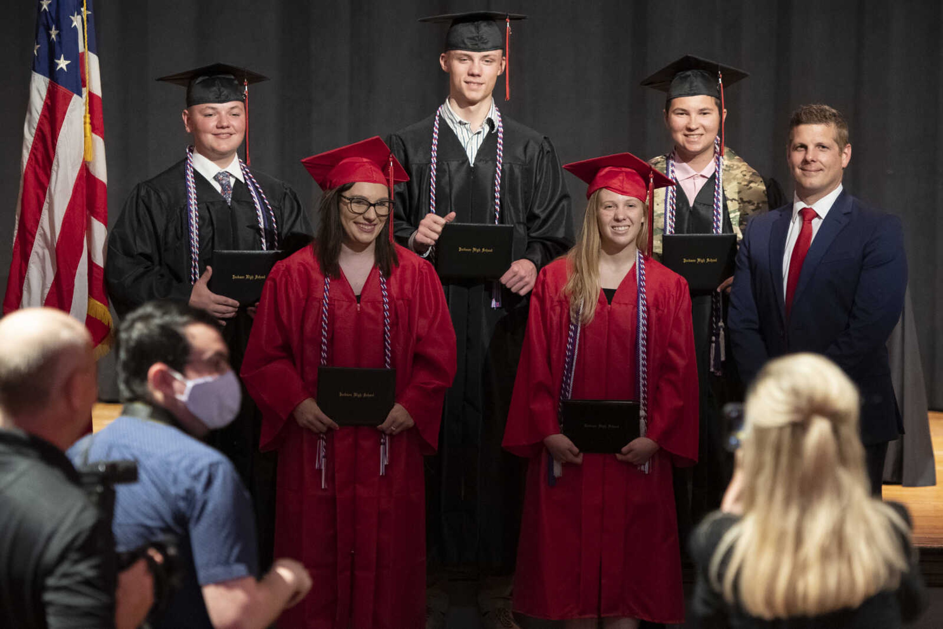 Jackson High School graduates (top row, from left) Caleb Scott Anderson, Jacob Charles Farrar and Logan Wayne McClanahan and (bottom row, from left) Amber Marie Lowes and Erin Taylor Huff take a picture with principal Seth Harrell (right) following an in-person military graduation ceremony Friday, May 22, 2020, at Jackson High School.