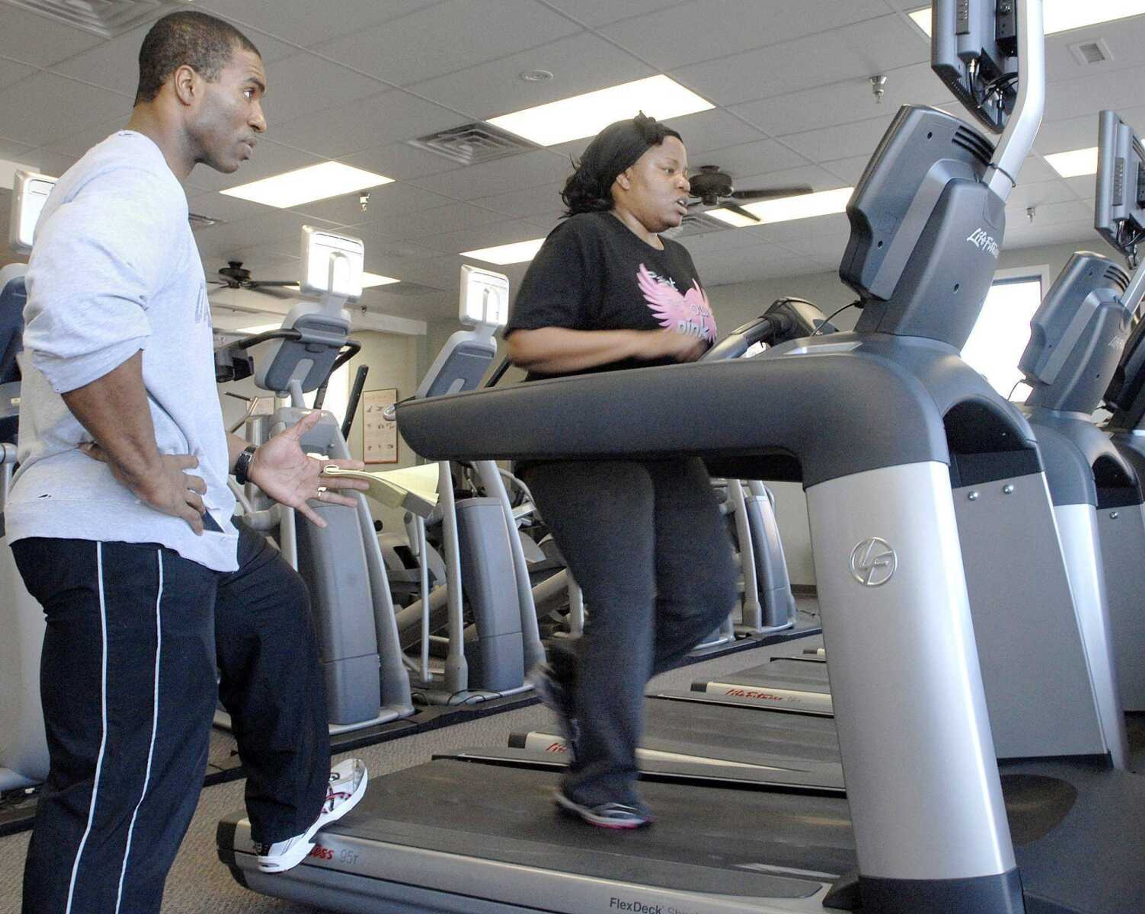 Shonda Hemphill of Cape Girardeau works out on the treadmill Saturday during her training session with Terrance Sterling at Anytime Fitness in Cape Girardeau. Hemphill started her fitness routine two weeks ago and keeps on a regular schedule with workouts every Tuesday and Thursday morning at five o'clock. (LAURA SIMON)