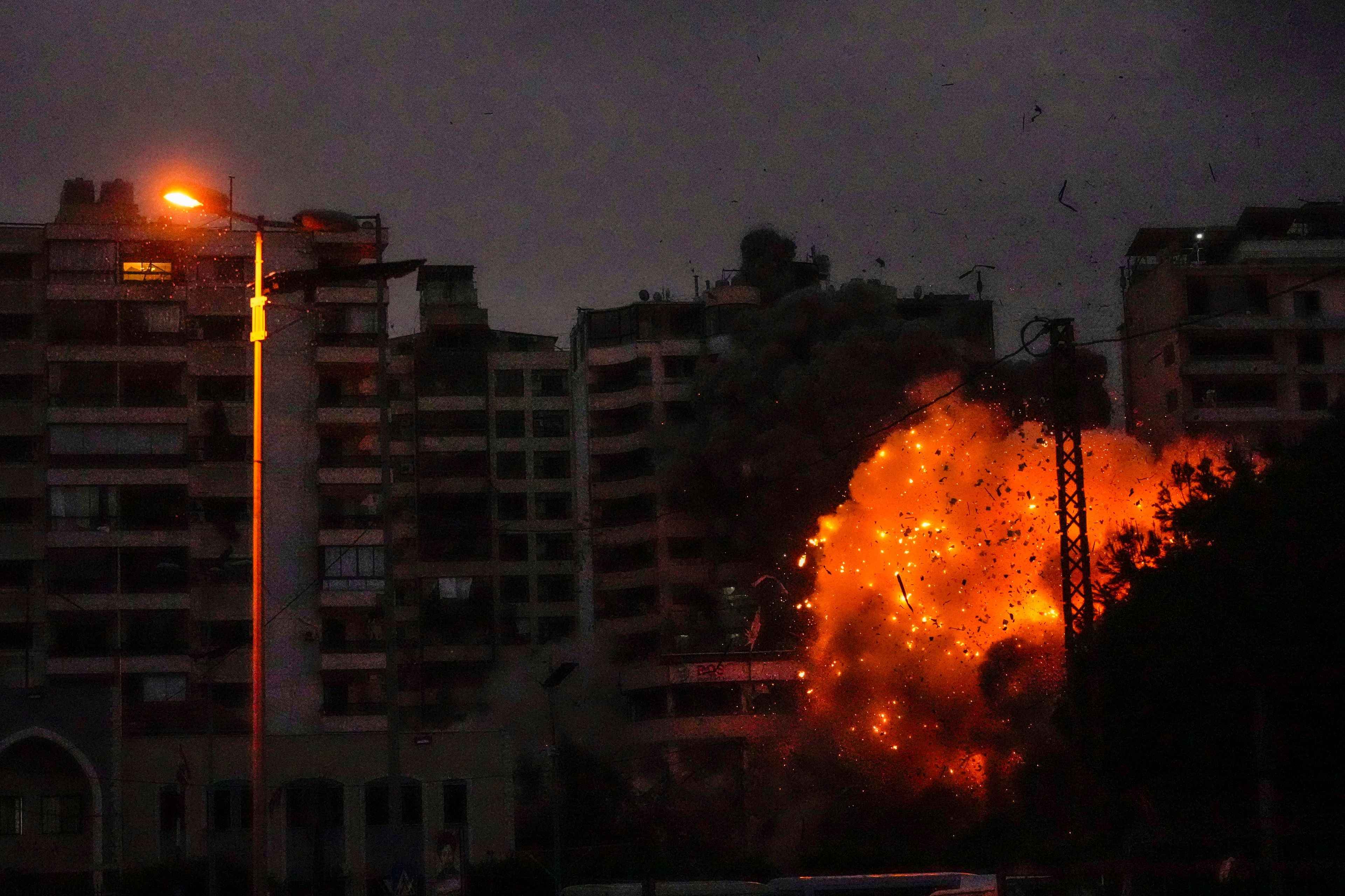 Thick smoke and flames erupt from an Israeli airstrike in Tayouneh, Beirut, Lebanon, Monday, Nov. 25, 2024. (AP Photo/Hassan Ammar)