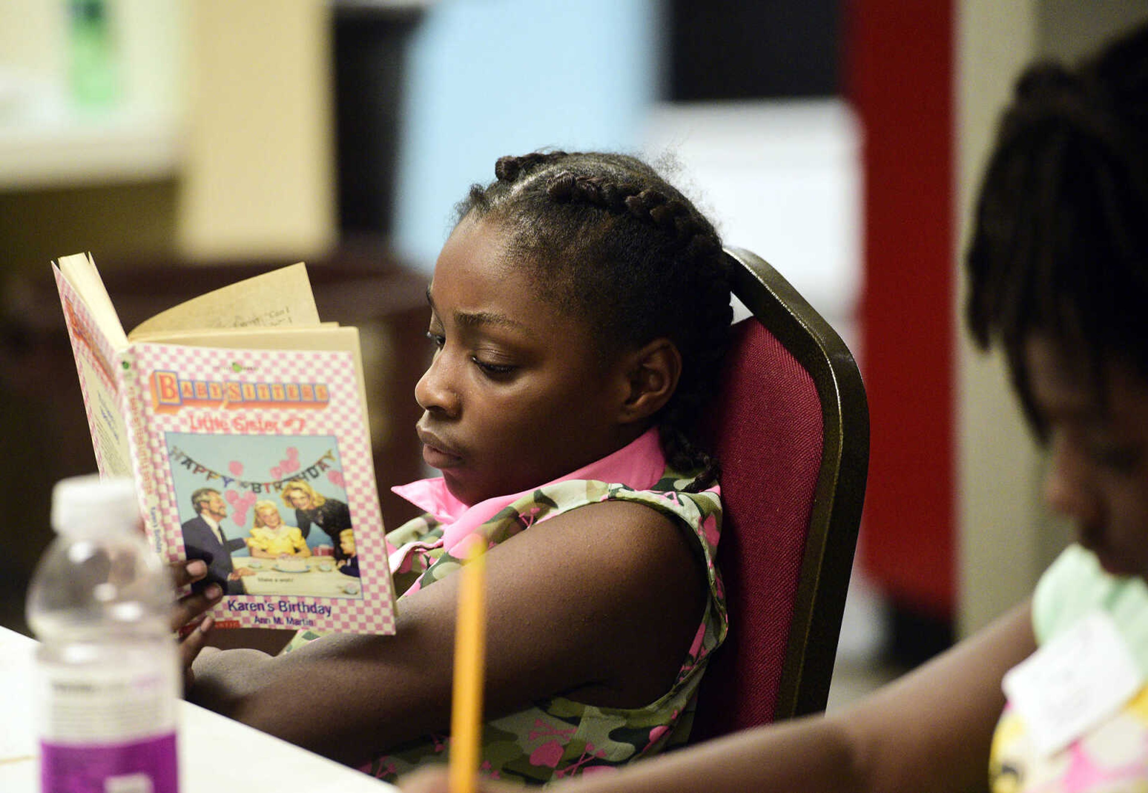 Shakira Jones reads a book on Monday, Aug. 14, 2017, during the Salvation Army's after school program at The Bridge Outreach Center in Cape Girardeau.