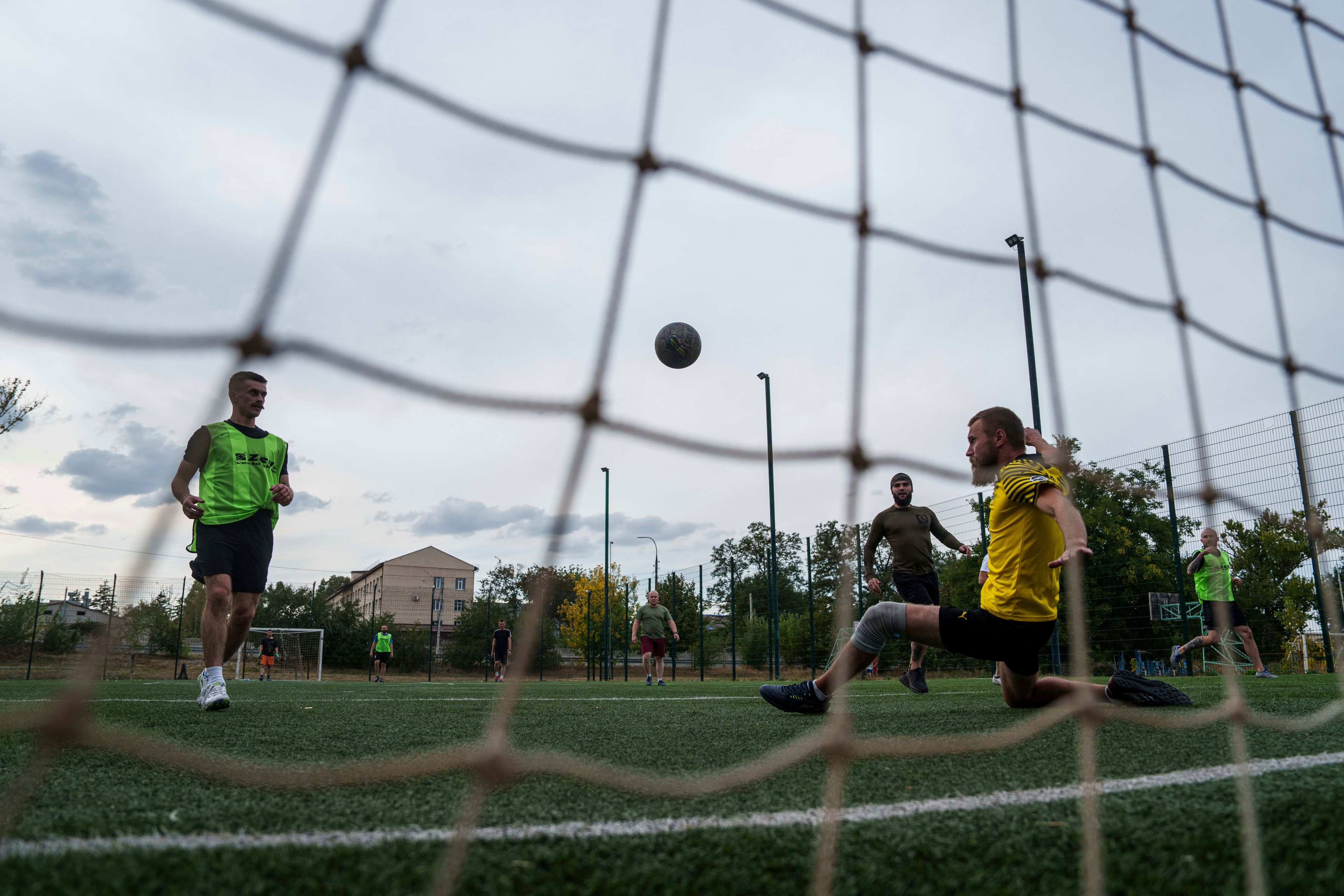 Ukrainian servicemen of 3rd assault brigade play soccer in Izium, Ukraine, Thursday Sept. 26, 2024. (AP Photo/Evgeniy Maloletka)