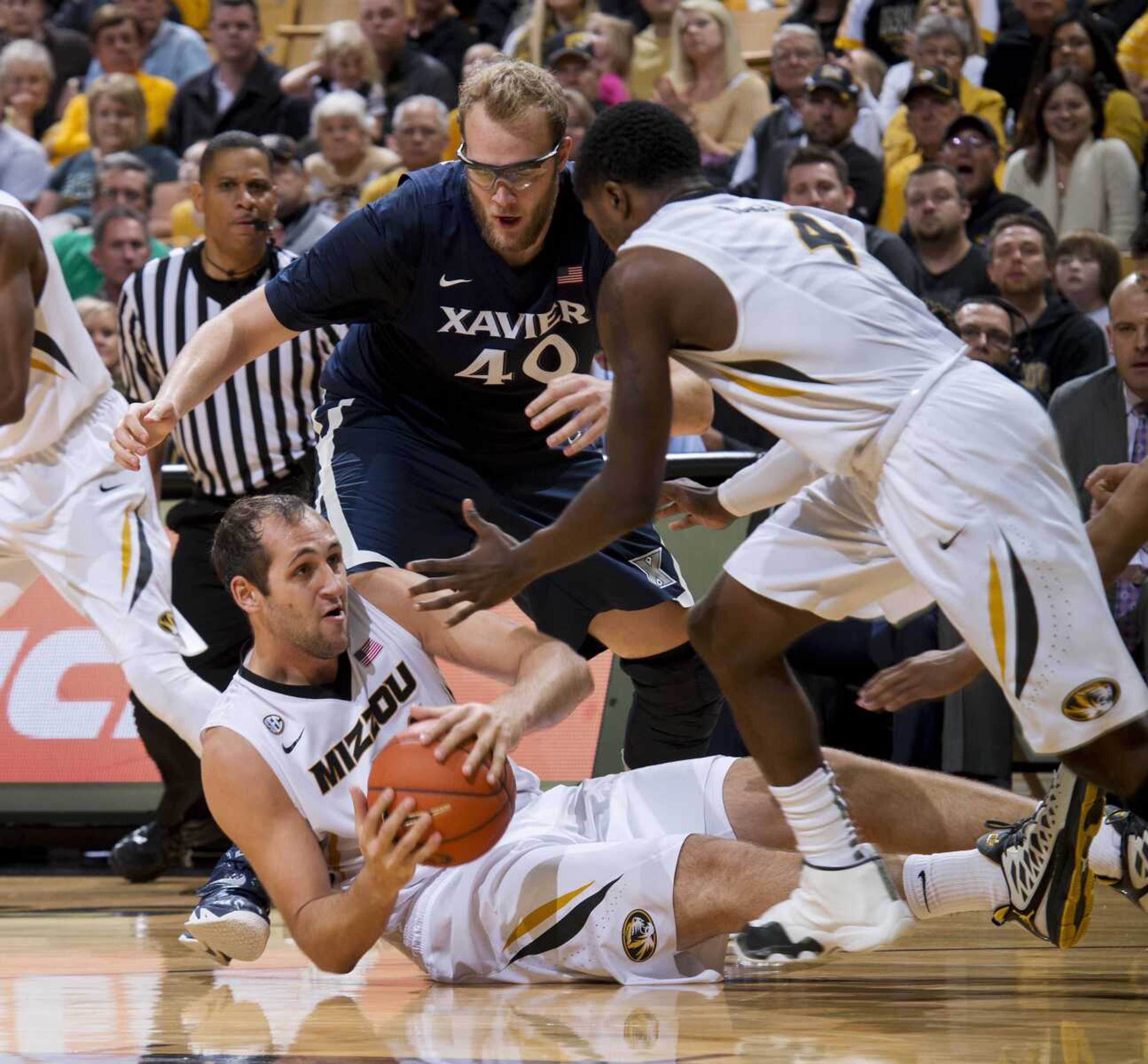 Missouri's Ryan Rosburg, bottom, looks to pass to teammate Tramaine Isabell, right, while Xavier's Matt Stainbrook attempts to steal during the second half of Saturday's game Saturday in Columbia, Missouri. (L.G. Patterson ~ Associated Press)