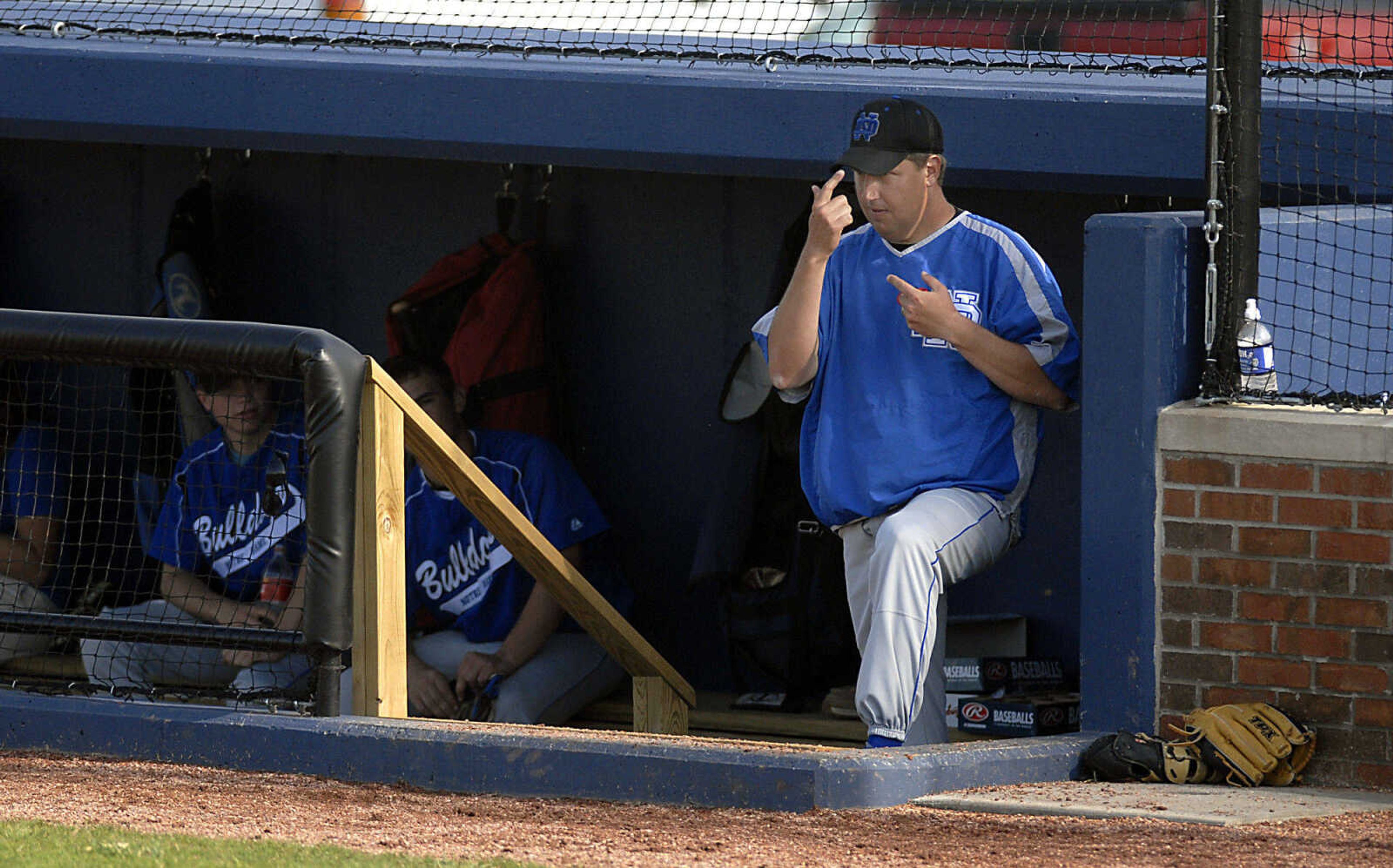 Notre Dame coach Jeff Graviett gives pitching signals Tuesday, April 28, 2009, against Sikeston in Cape Girardeau.