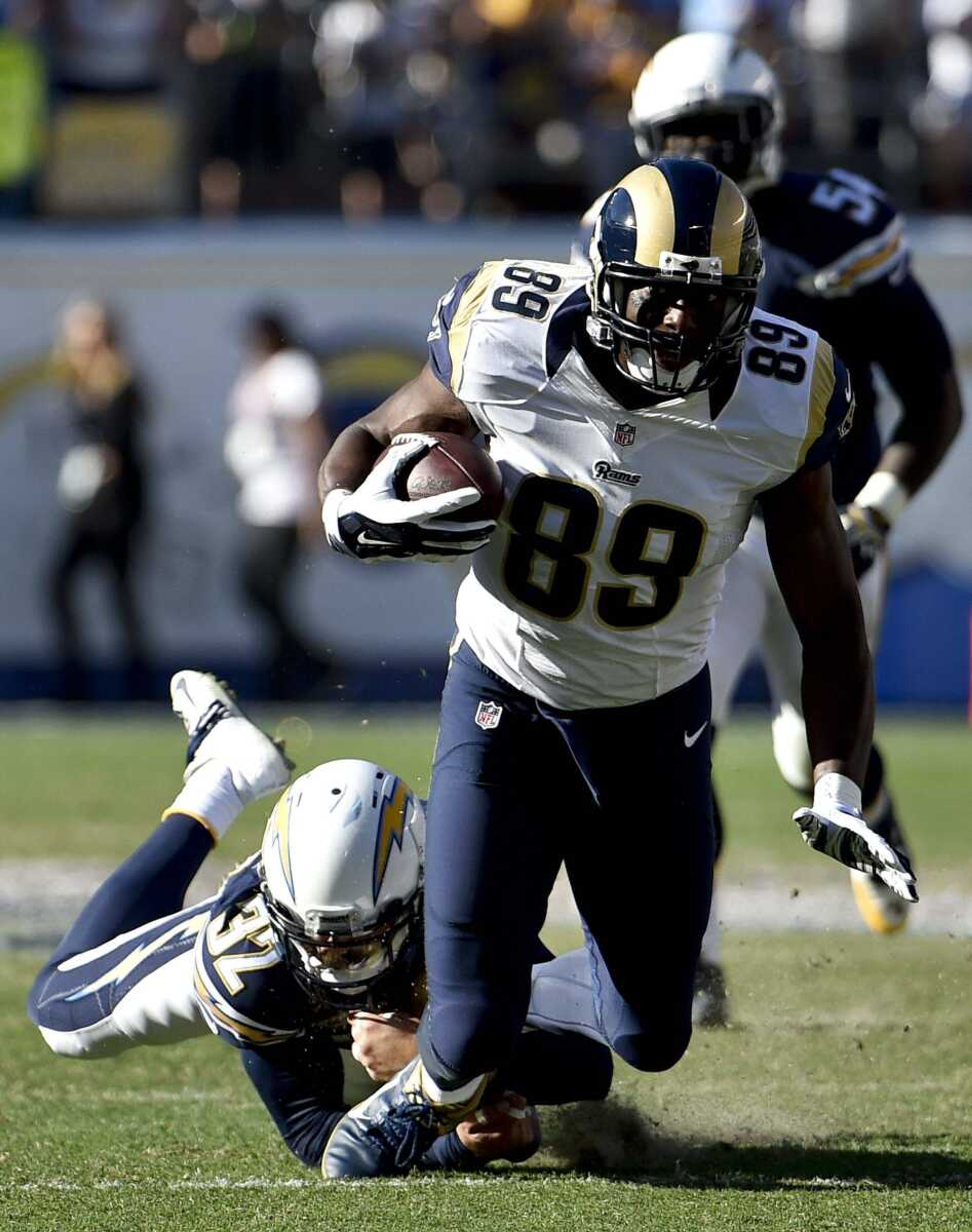 Rams tight end Jared Cook is tackled by Chargers safety Eric Weddle during the first half Sunday in San Diego. The Chargers defeated the Rams 27-24. (Denis Poroy ~ Associated Press)