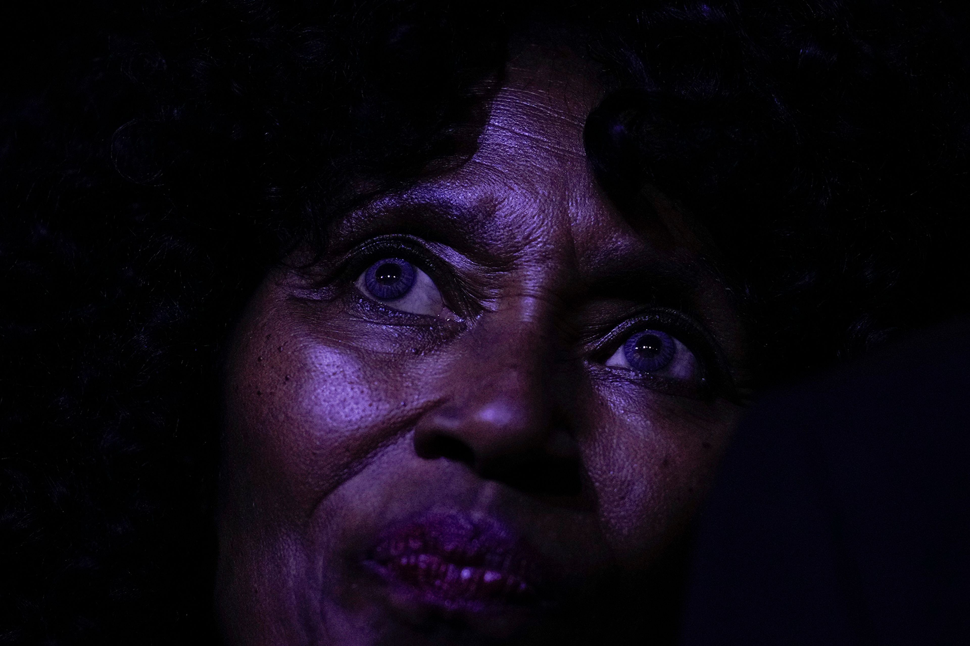 A voter watches the stage before former first lady Michelle Obama speaks, Tuesday, Oct. 29, 2024, in College Park, Ga. 