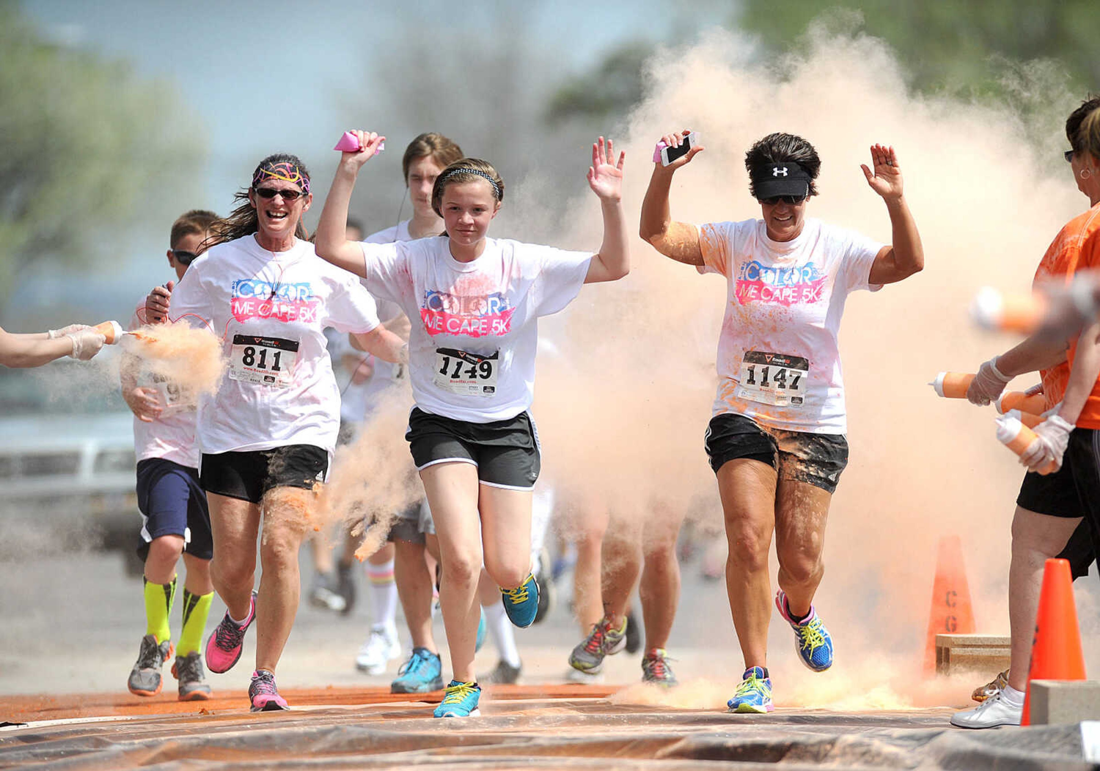 LAURA SIMON ~ lsimon@semissourian.com

Participants in the Color Me Cape 5K are sprayed with orange powder at the first color station on Good Hope Street, Saturday, April 12, 2014, in Cape Girardeau.