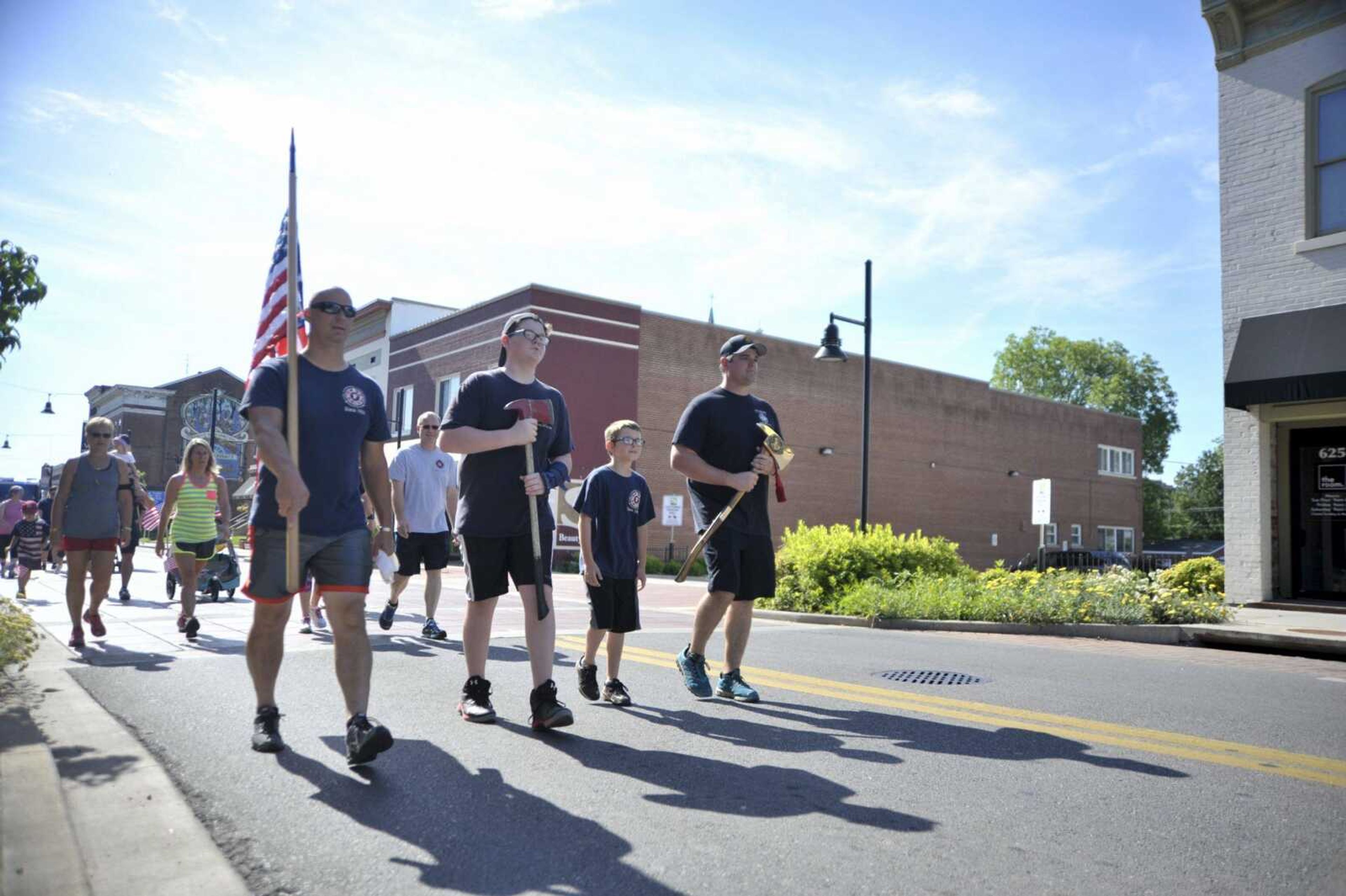 Participants in a Carry the Load walk during a parade down Broadway in Cape Girardeau on Monday to show support for military personnel and first responders. The parade began at the intersection of Water and Broadway and ended at Cape Girardeau County Park North.