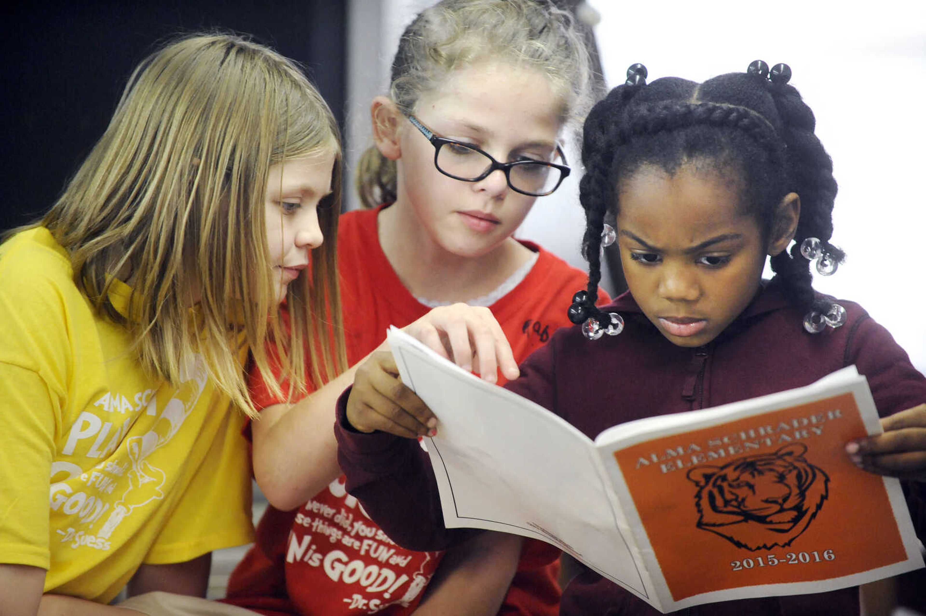 LAURA SIMON ~ lsimon@semissourian.com

Emily Griffith, left, Gabby Benn, center, and Nevaeh Morris look through the Alma Schrader yearbook Monday afternoon, May 9, 2016, at the Boys and Girls Club of Cape Girardeau.