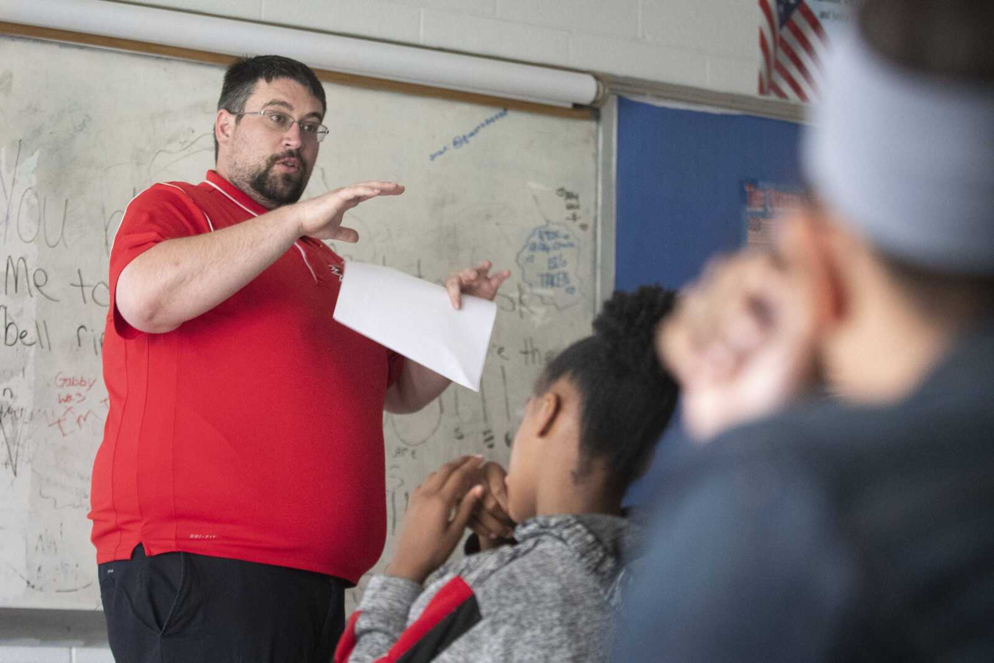 Meridian junior high social studies teacher Alex Washam of Mounds, Illinois, speaks with students May 7 at Meridian High School in Mounds.