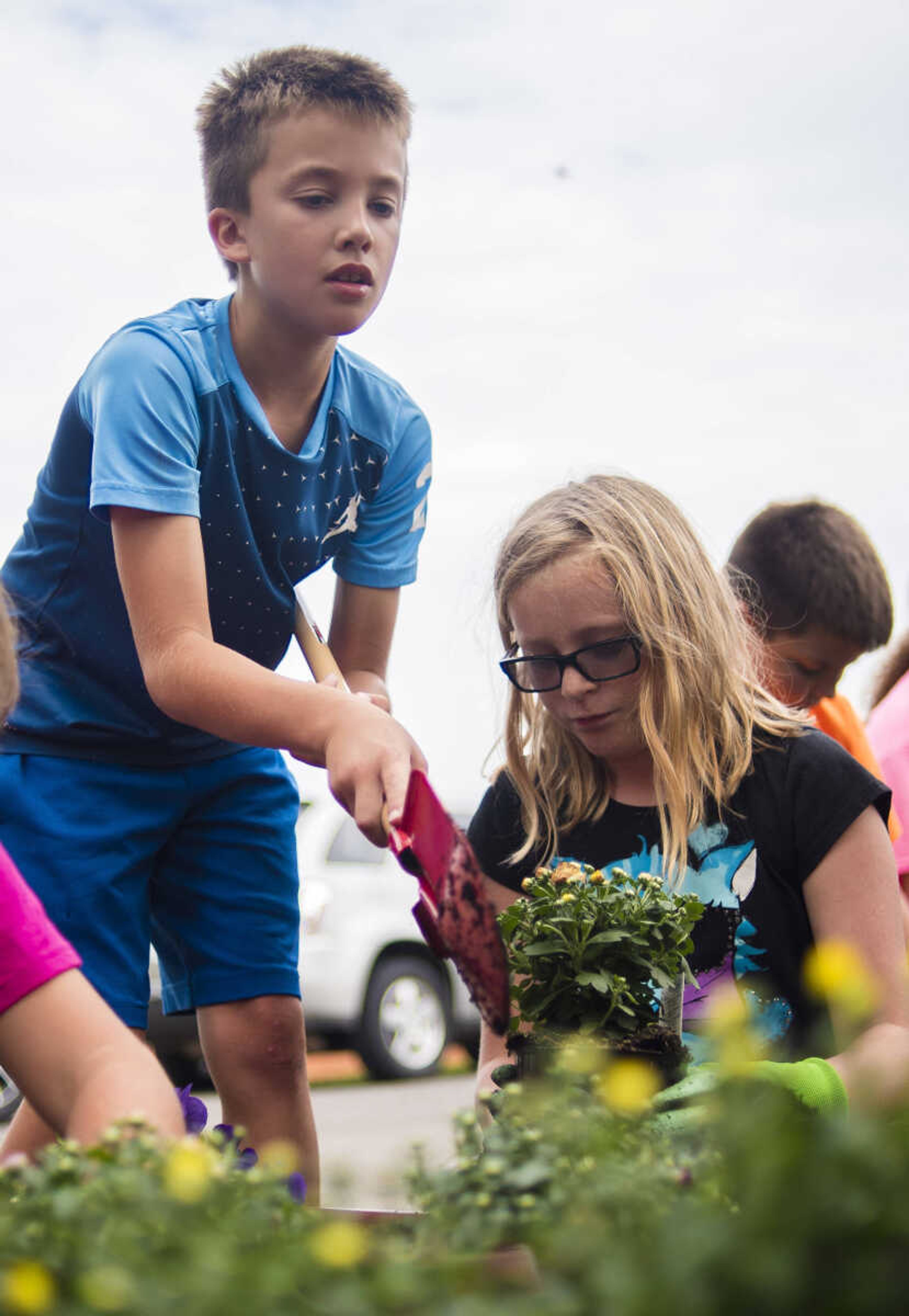 Drew Rigdon and Kirstin Dietiker plant pansies and mums in flower beds donated by Lowe's as part of the Lowe's Heroes program Monday, Sept. 18, 2017 at West Lane Elementary in Jackson. Lowe's donated 12 flower beds, 10 picnic tables and three new benches for the school.