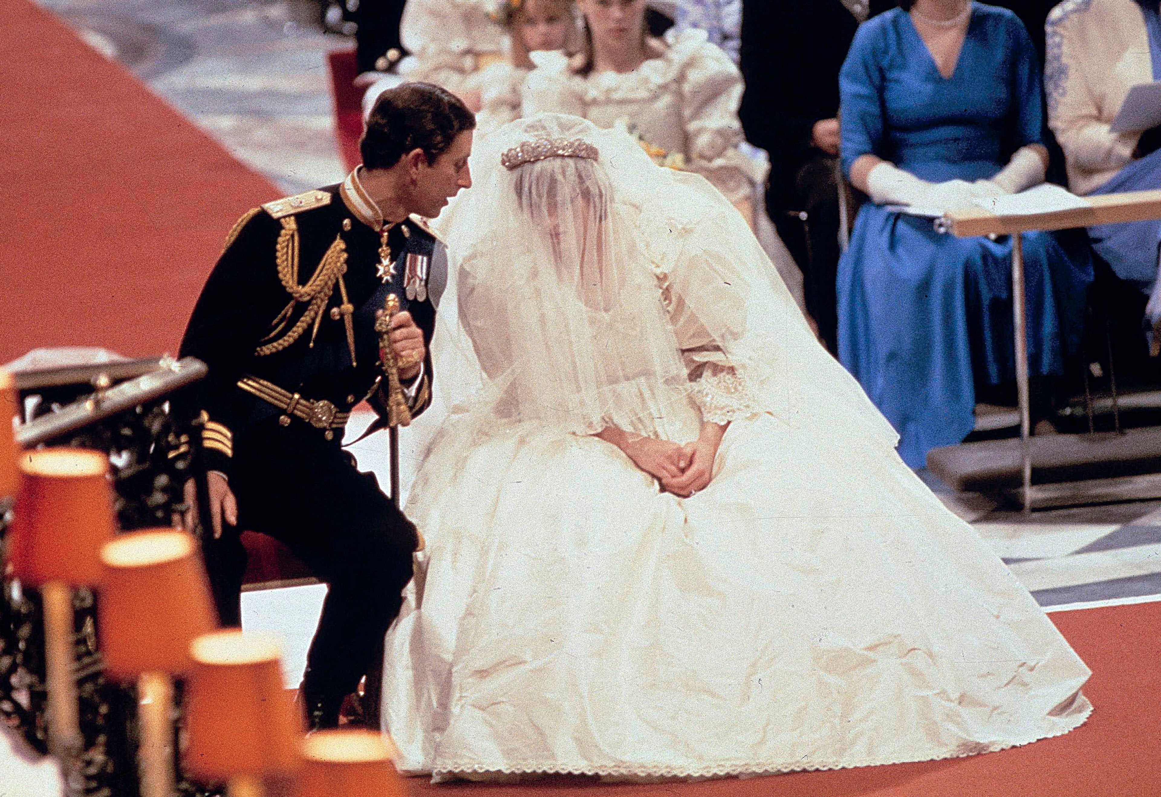 FILE - Britain's Prince Charles speaks with his bride Princess Diana, during their wedding ceremony in St. Paul's Cathedral, London, July 29, 1981. (AP Photo/File)